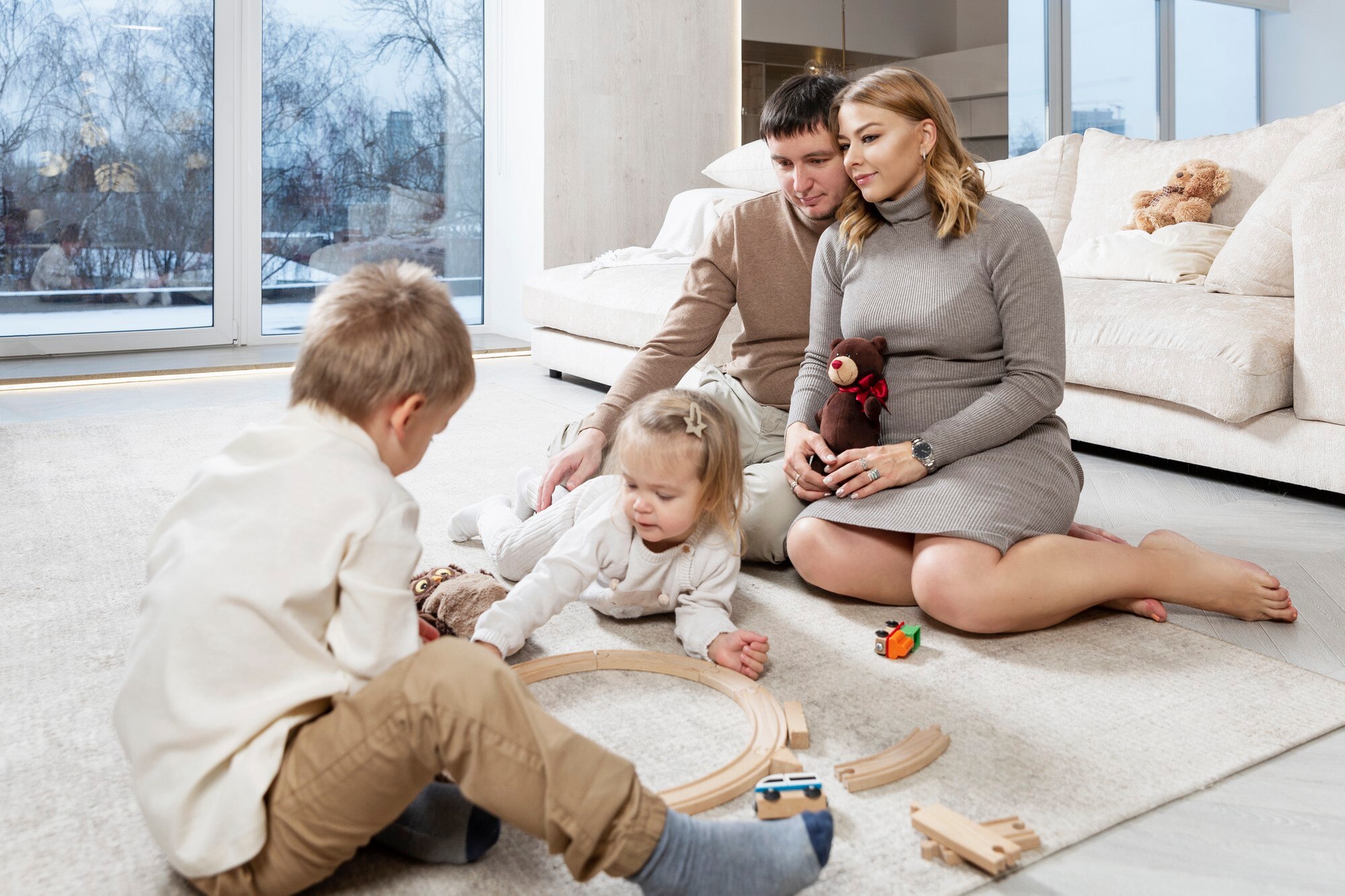 happy young family with small children are sitting 2b69bd6157970babee6e