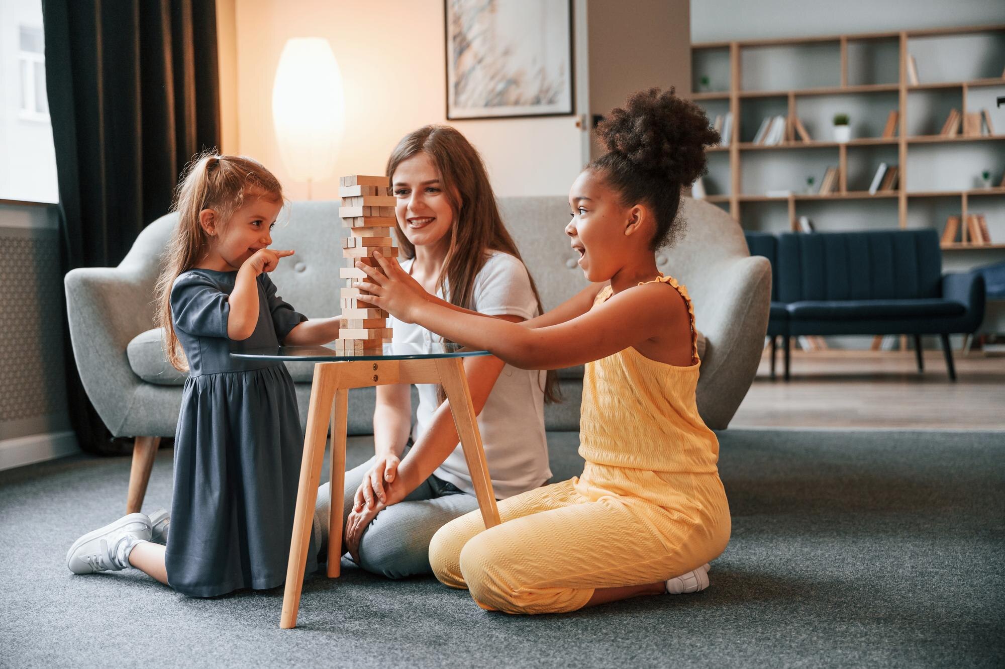 having fun a young woman with two girls is playing dd16c58cb126620bfc0c