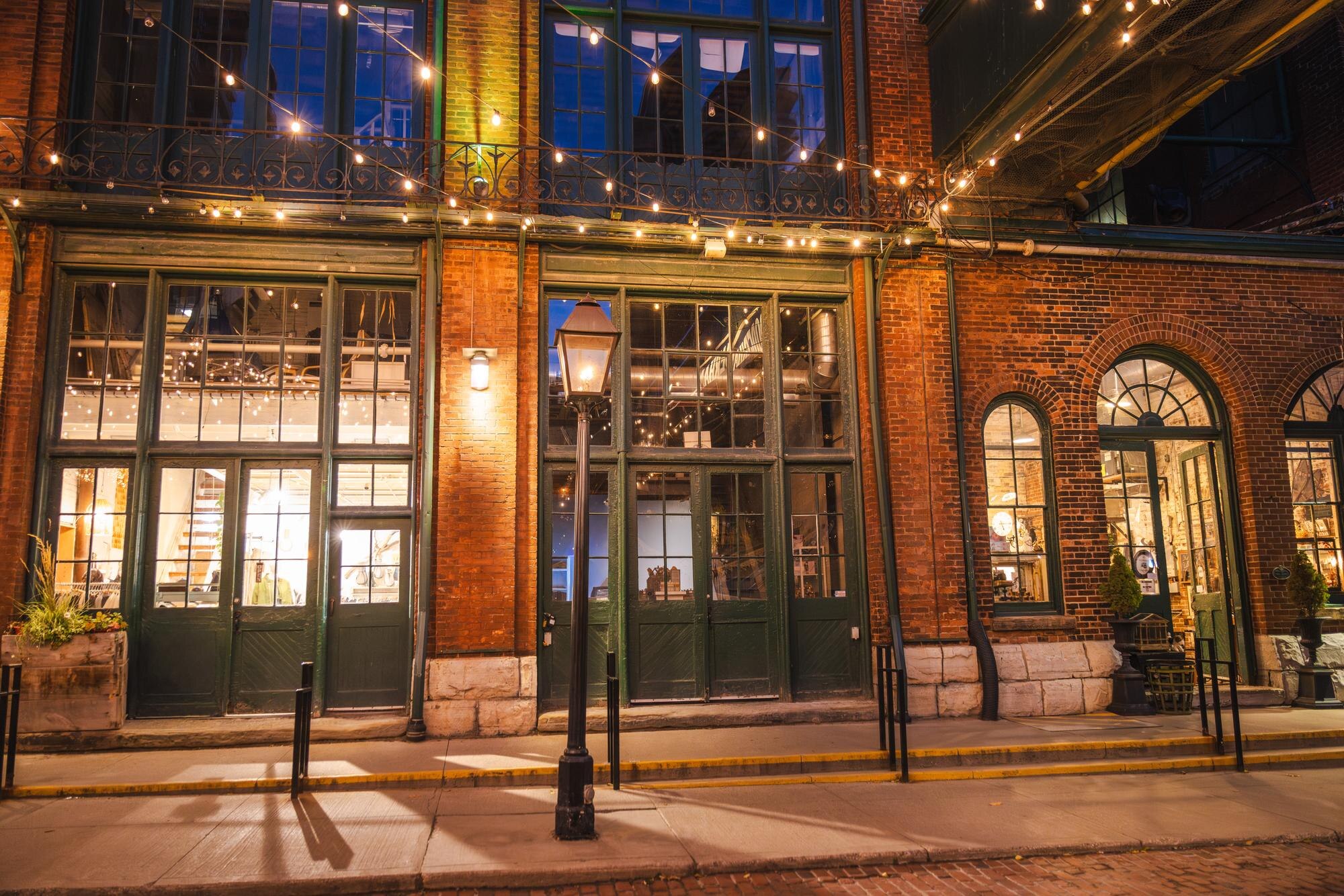 historic brick storefronts illuminated by warm lig 8cc8b8ff5b8ea4bed6f3