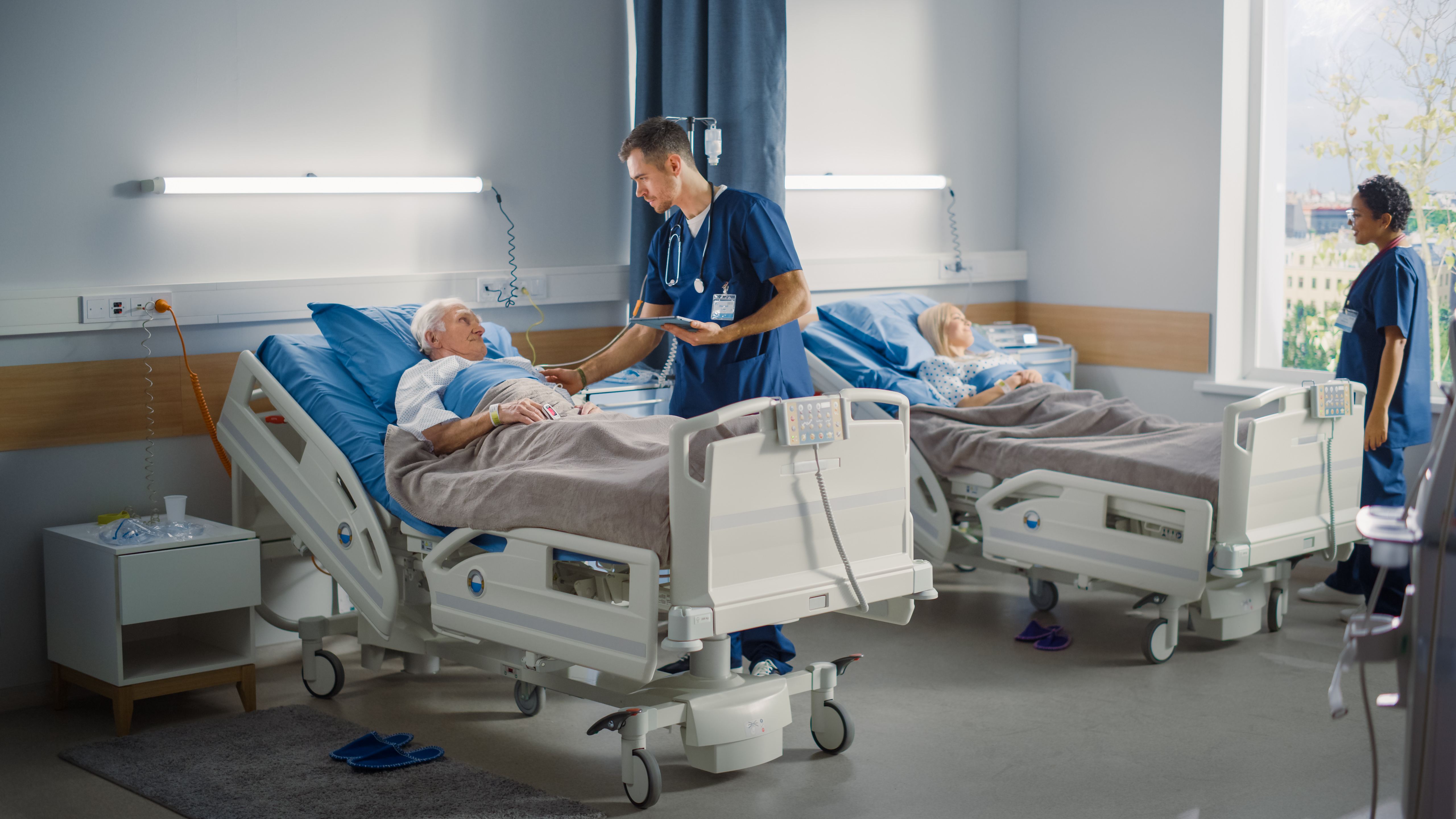 hospital ward friendly male nurse talks reassurin 204fc23e22bfb113718a