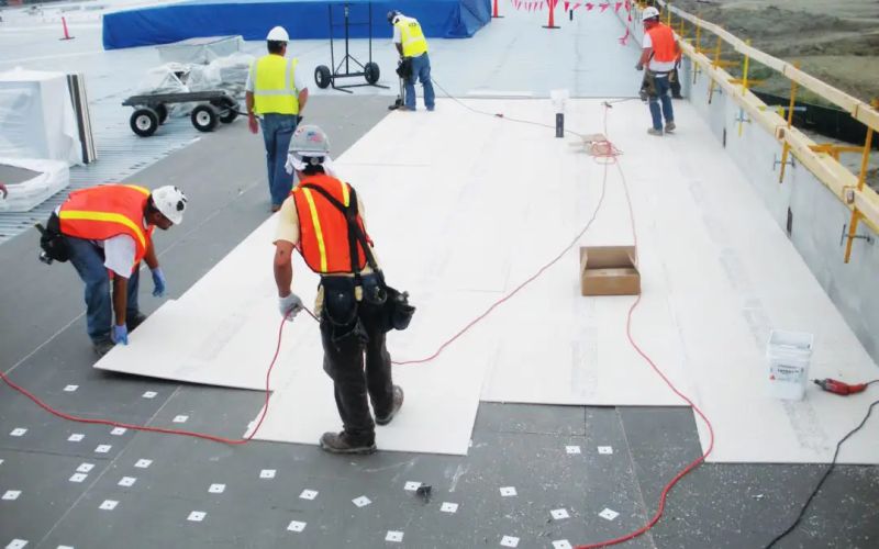 Commercial rooftop with new roof and solar panels under a no‑cost roof replacement and solar program