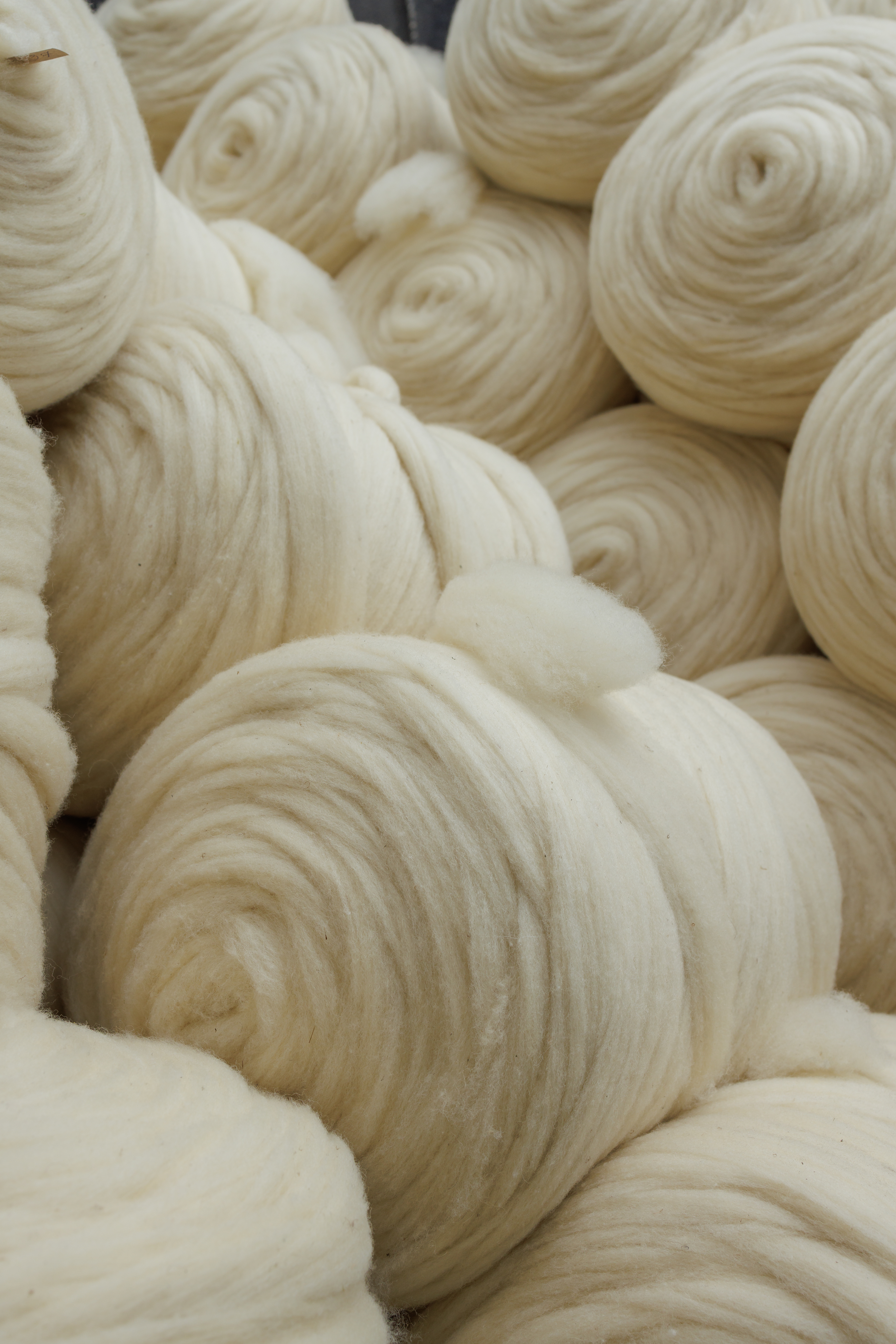 Close-up texture of natural wool fibers, showing its soft and breathable structure