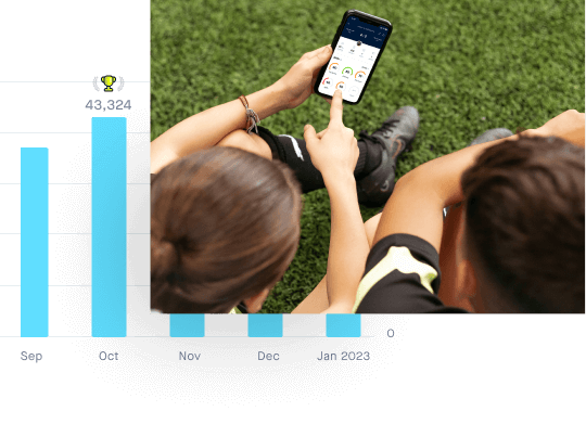 2 soccer players looking at Playermaker statistics at iLOVEthisGAME