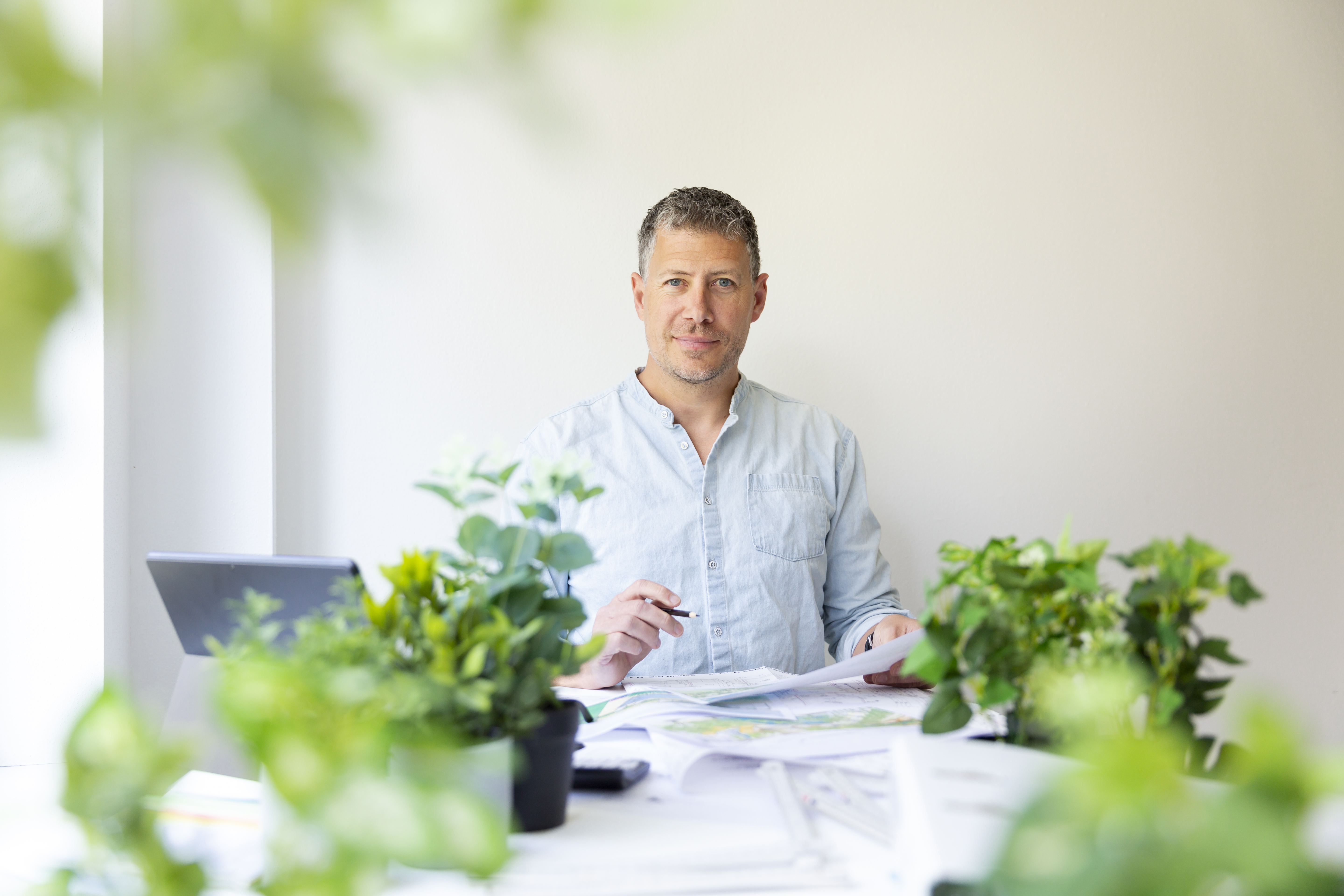 landscape designer gardener with blue shirt sits a 7a8aa59eae38c720732d