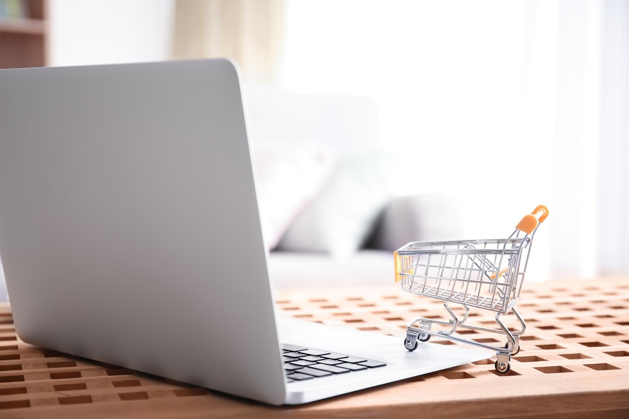 laptop and small shopping cart on table internet s 5202d9d92b2a3b9e4002