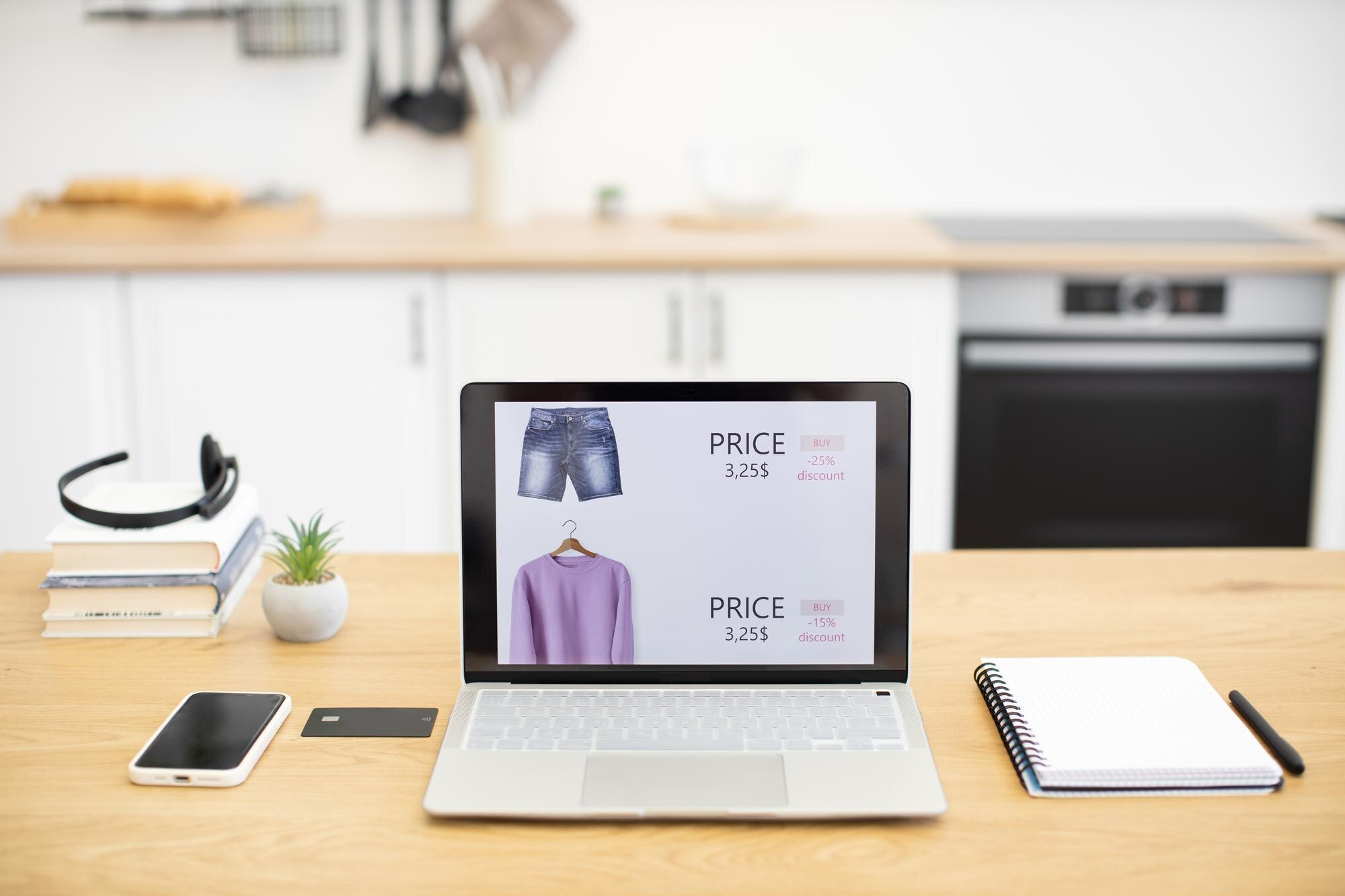 laptop displaying online clothing store on wooden b99b049b8d1719b28525