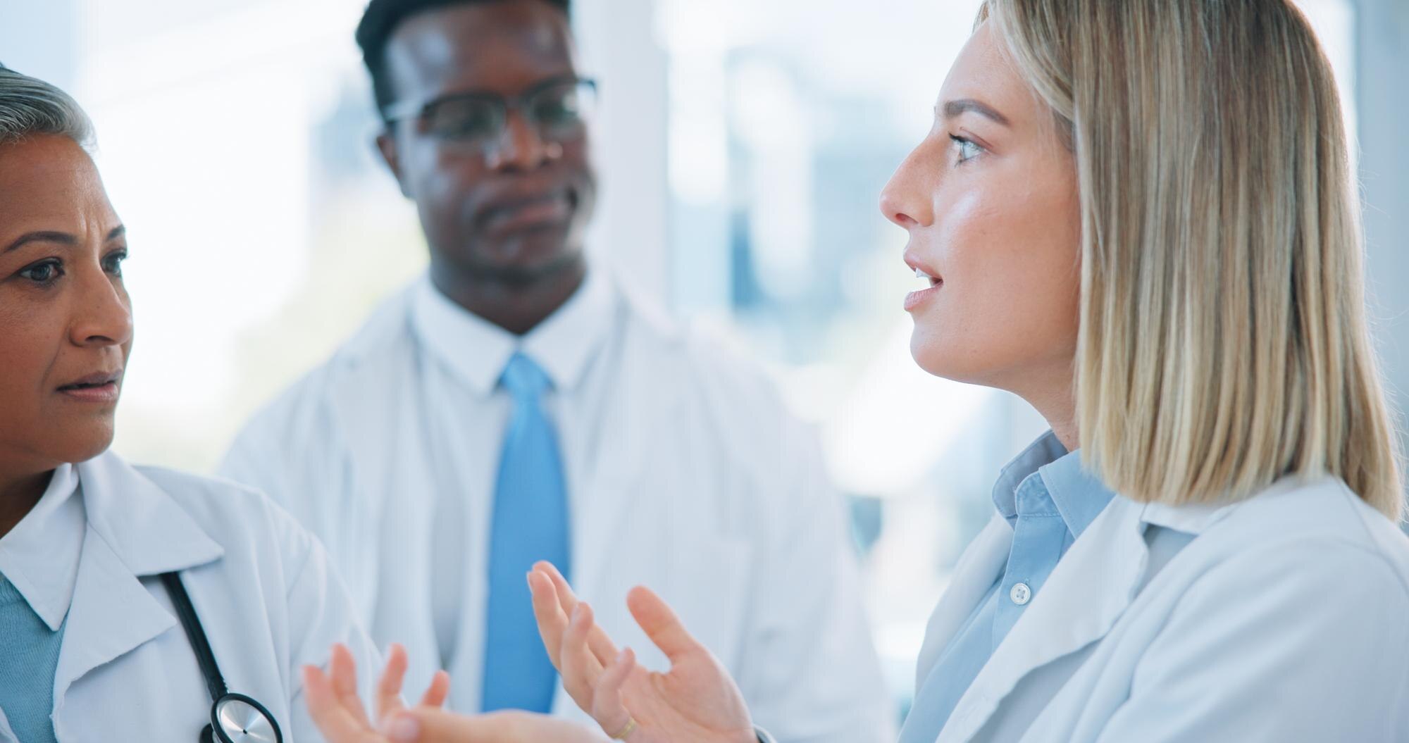 Mastering Oet Listening: Leverage Real-World Healthcare Conversations To Boost Your Skills 2 image of three healthcare workers in a conversation. An illustrative image for healthcare conversation and OET preparation.