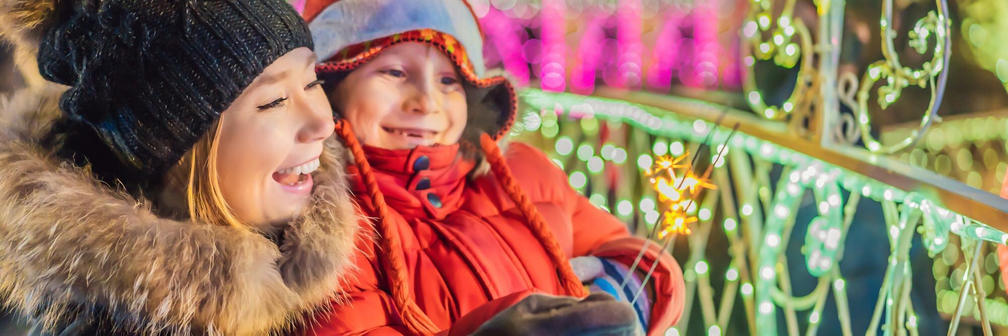 little boy and his mother with sparklers near gian 83196ed766308237a795
