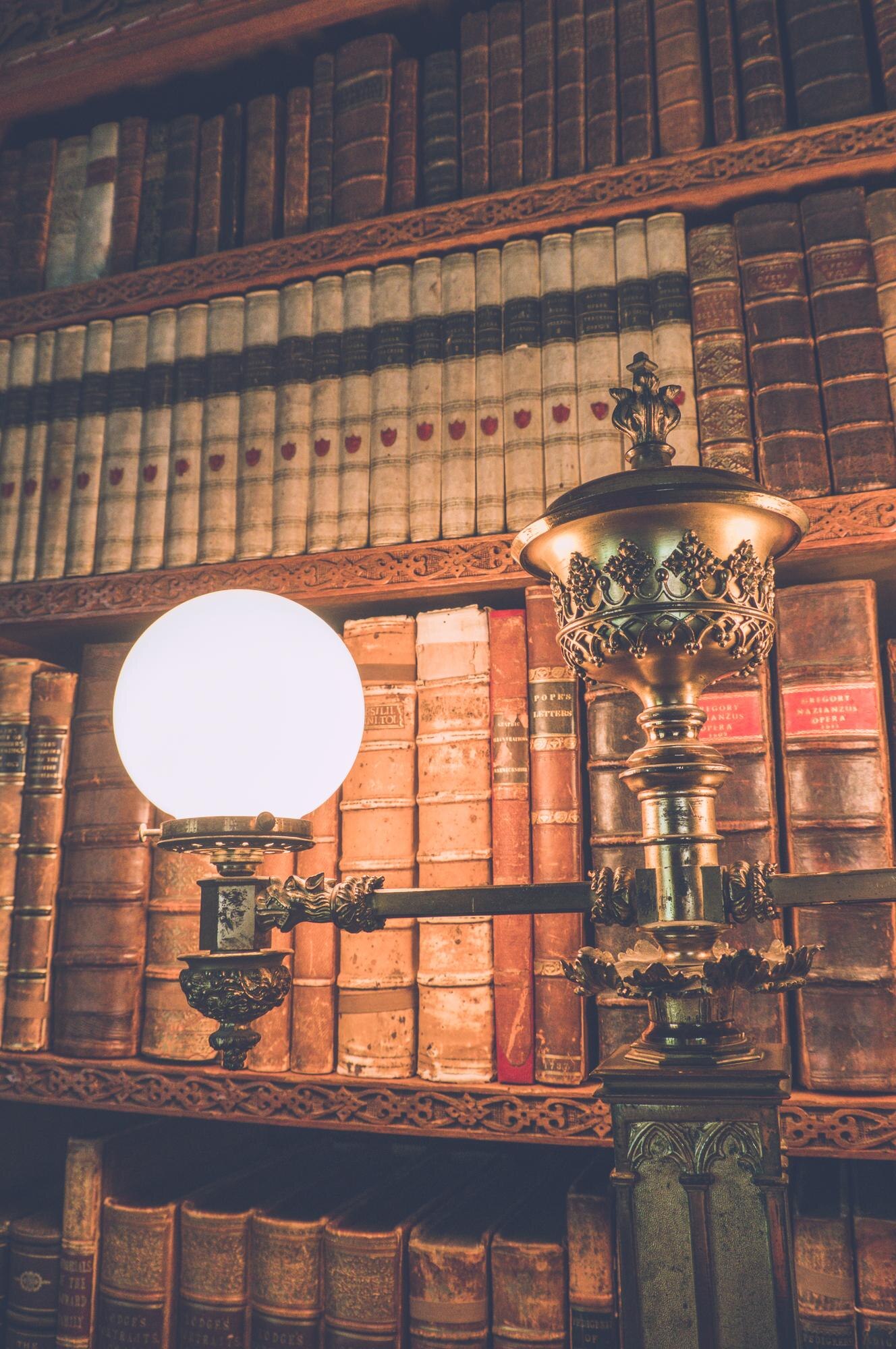 low angle view of illuminated lamp against bookshe d6f88f3caffb4b7bdeee