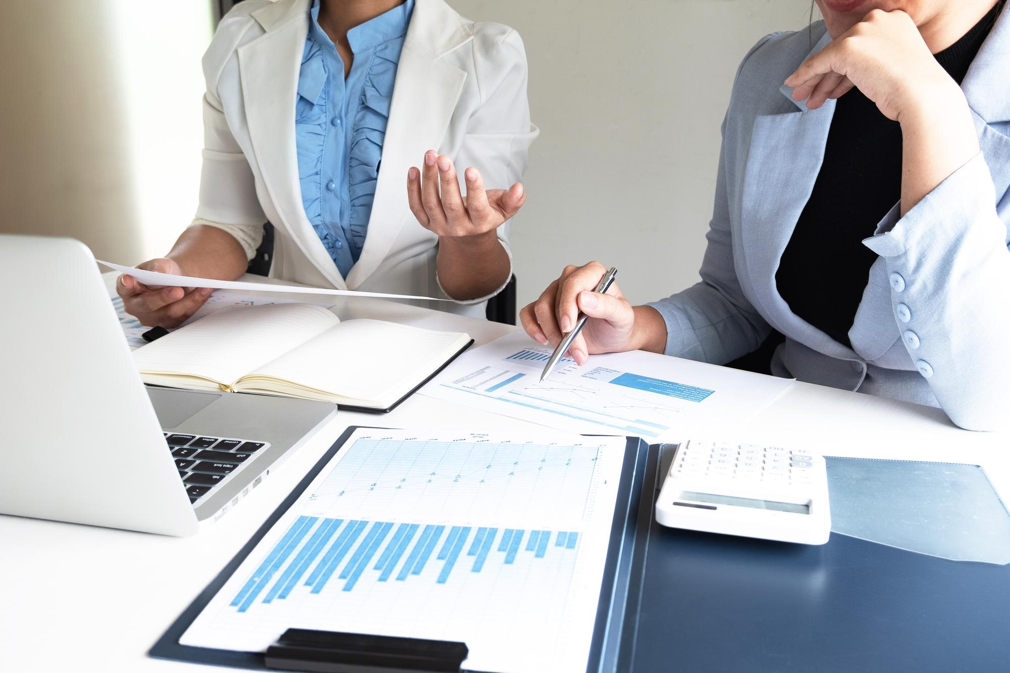 Healthcare consultants reviewing ways to reduce medical practice expenses