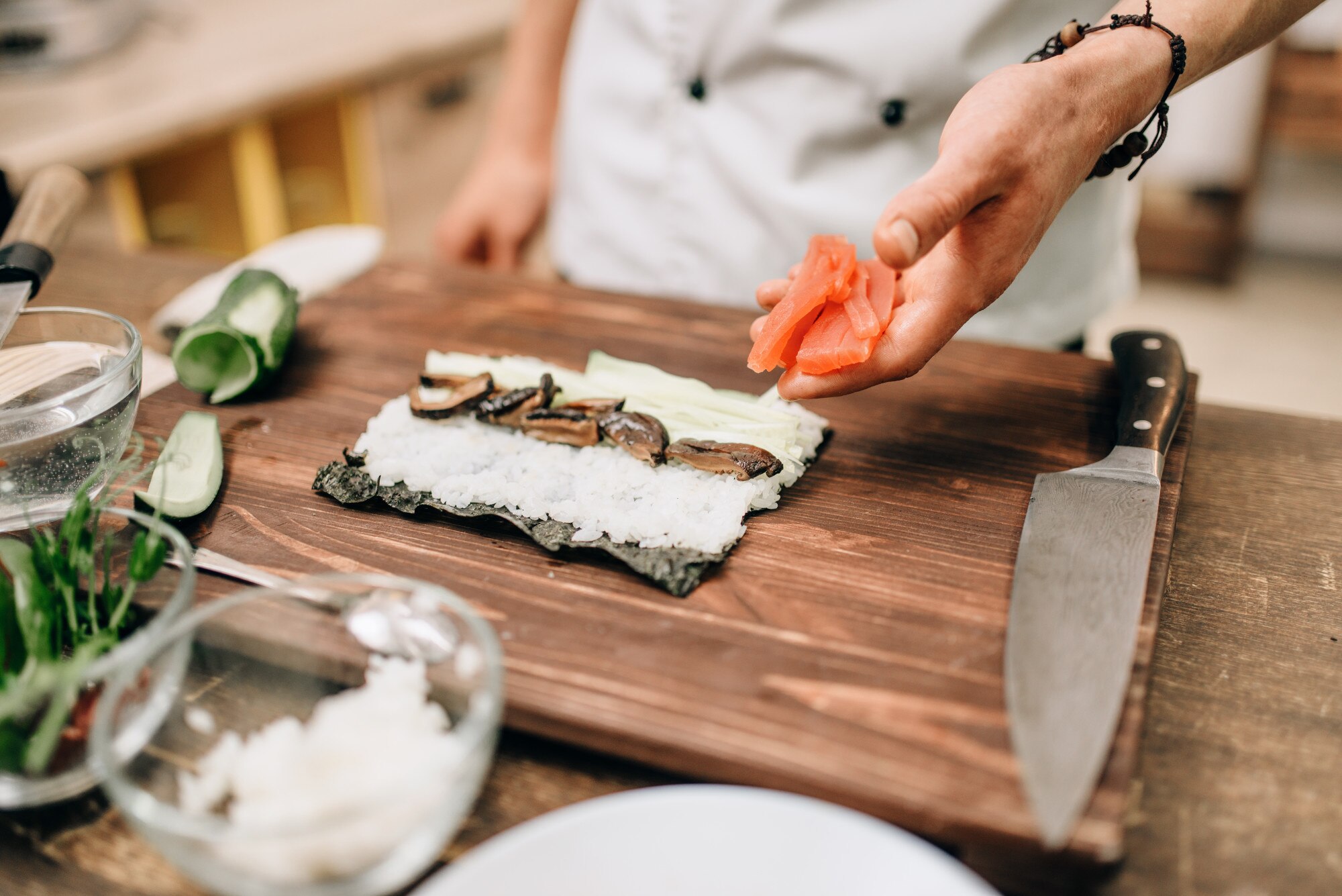 male cook making sushi on wooden table a33344330308c68f636b