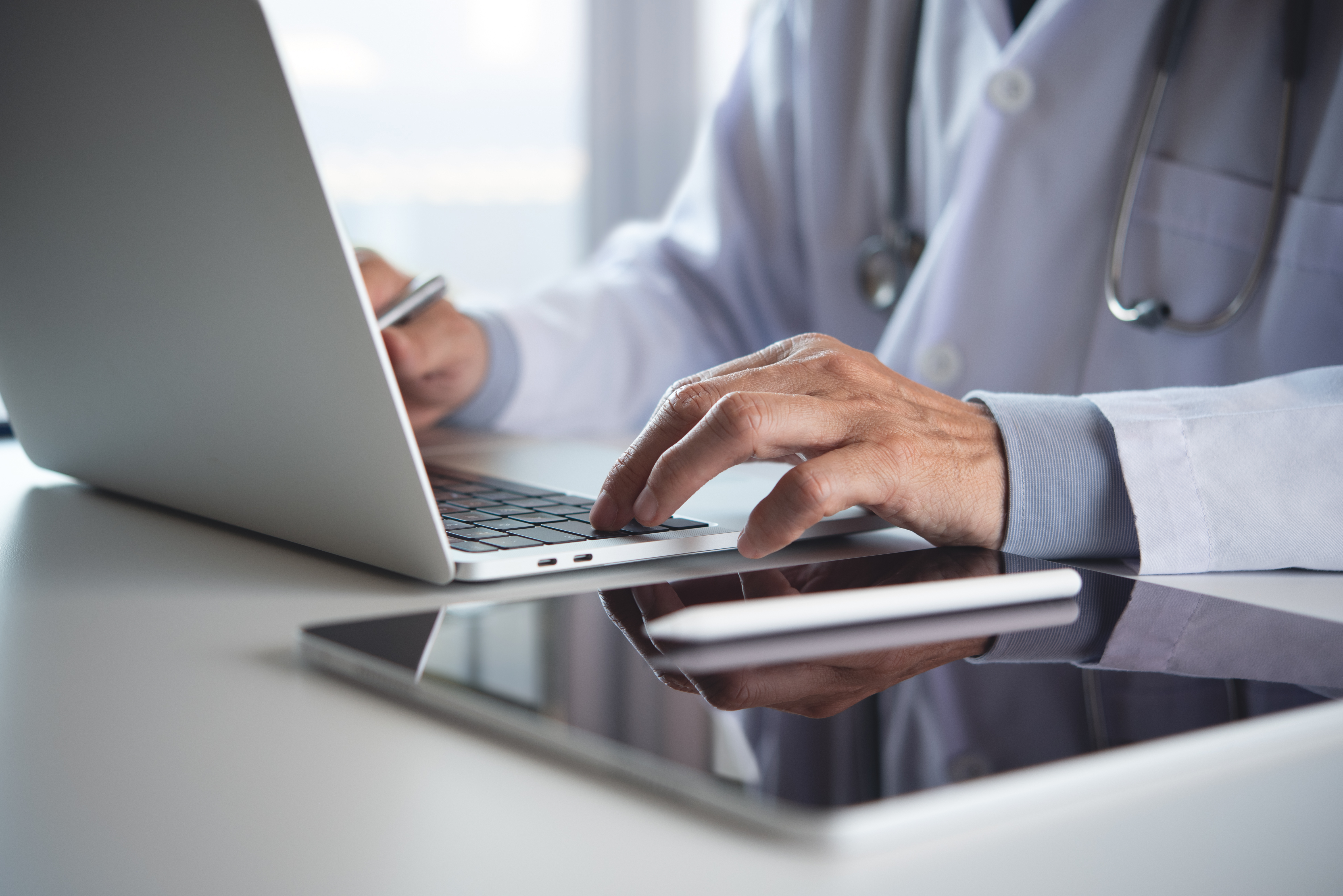 Balancing Professionalism and Approachability in Brand Messaging for Health and Wellness Professionals 2 - MedWell Digital Marketing Agency male doctor working on laptop computer in medical 9c015ac7d8ba275f4b2e - MedWell Digital Marketing Agency