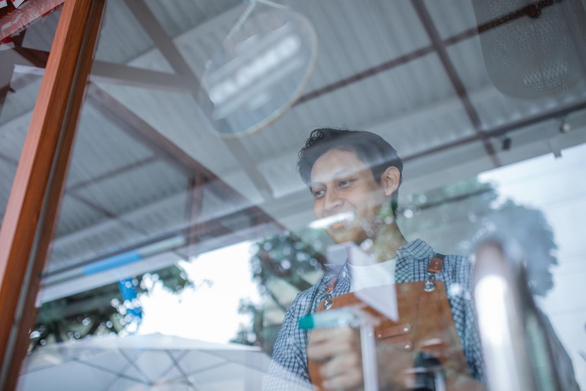Made Here Matters: How Local Plastic Manufacturing Drives Sustainability and Innovation in Australia 2 male waiter wearing apron cleaning glass window wi 2088e9b99f9daa00ad39