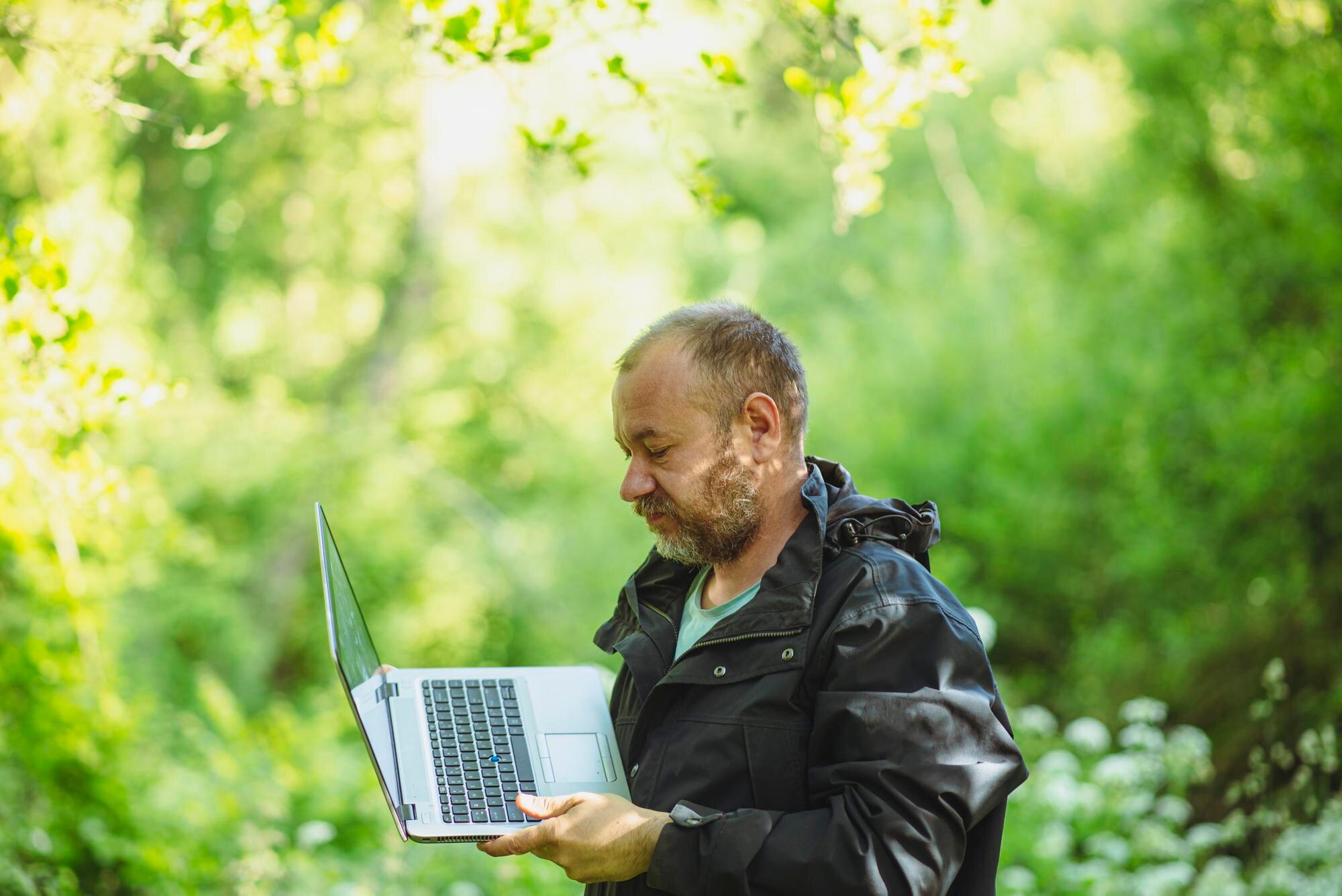 man 43 years old in the forest with a laptop b593b38ff5b121713053