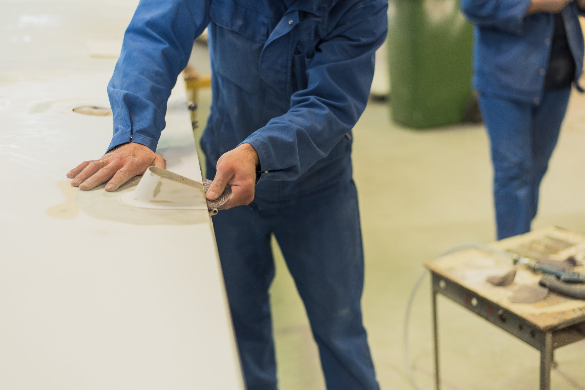 Why Local Plastic Fabrication Gives Australian Businesses the Edge 3 man aligns sandpaper wing worker polishes the wor ccc653ae81bd49456fbe