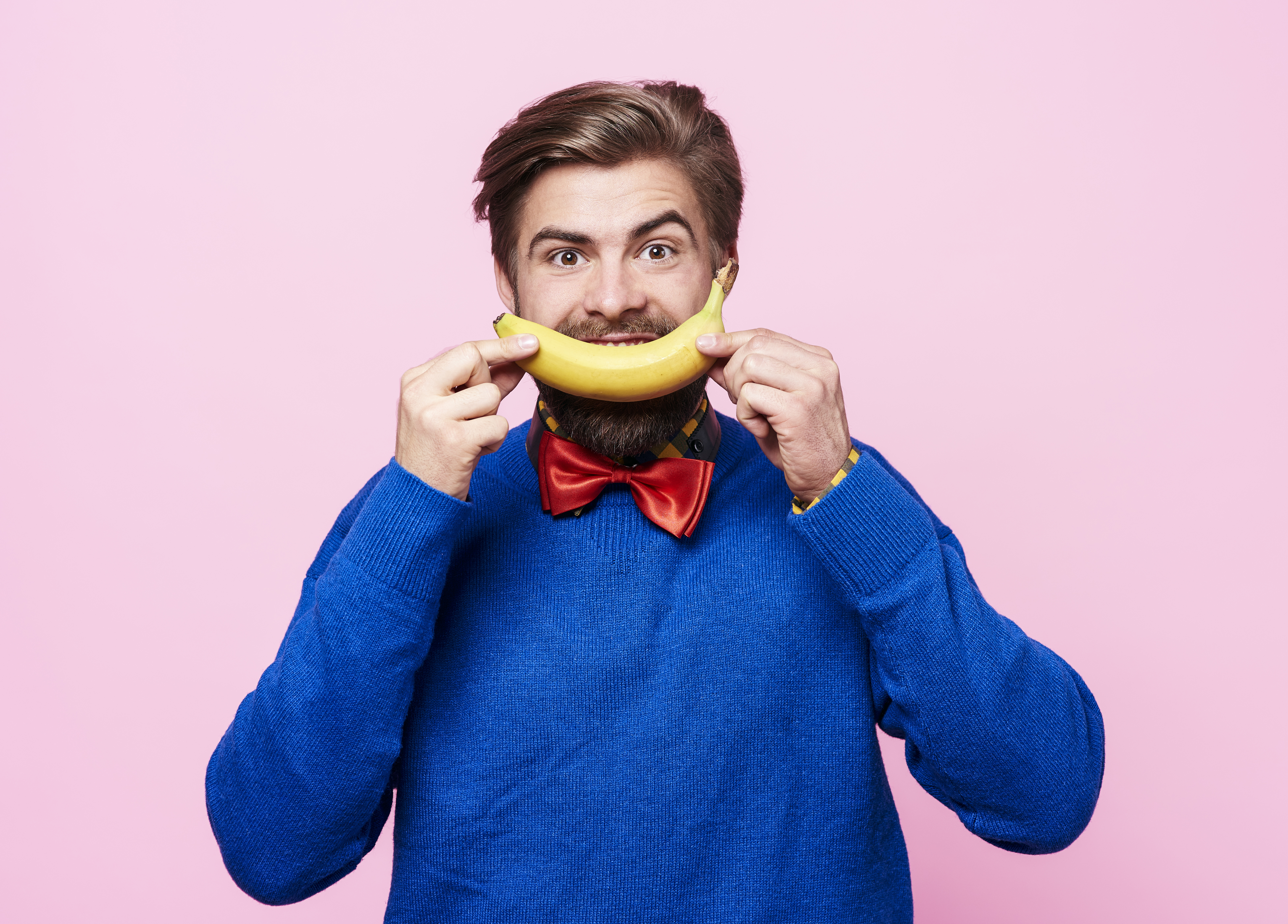 man holding a banana in front of his mouth b017f3cb116d45d5e2b7