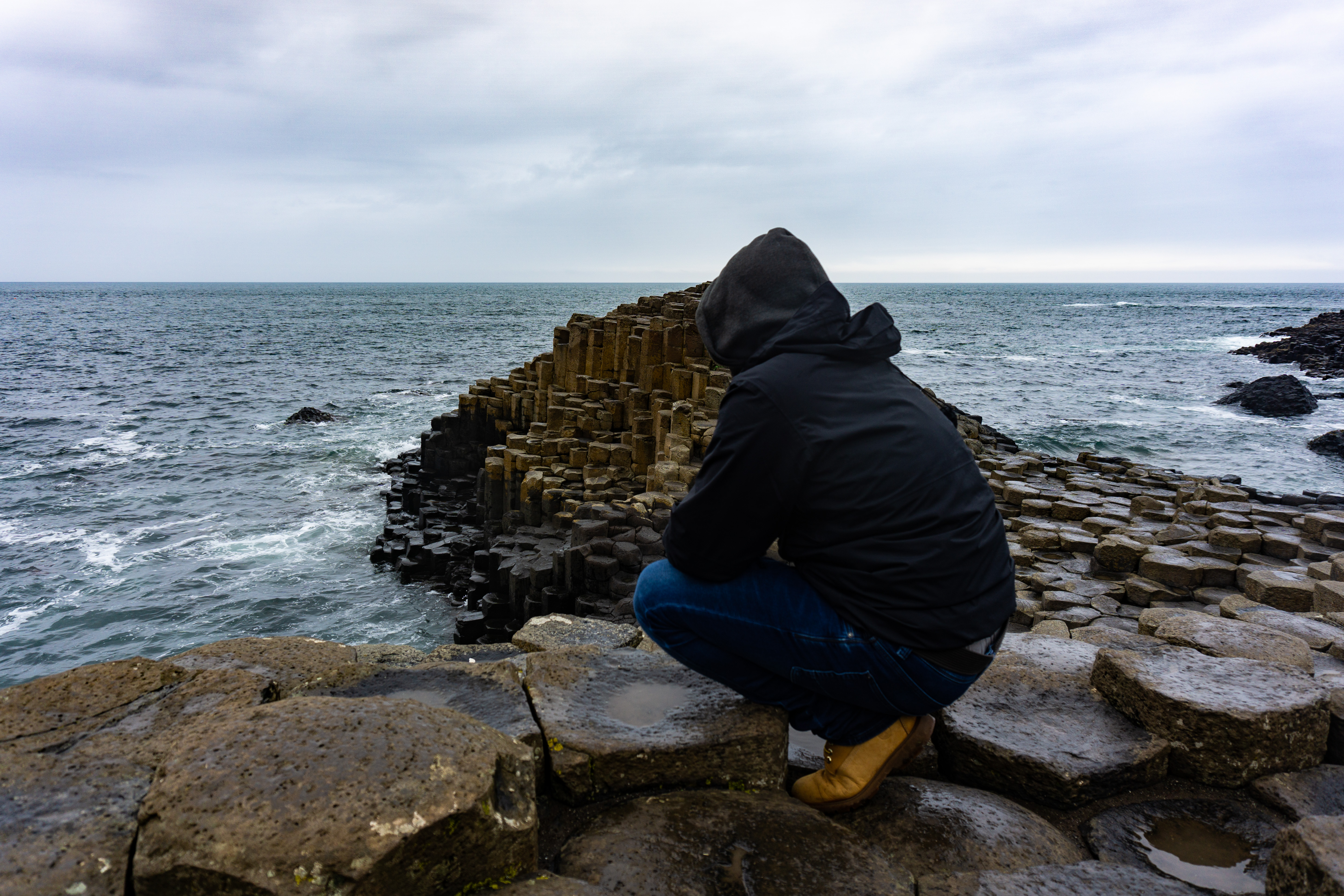 man is looking at the atlantic ocean on the giant 3f8e62be11b3e99ffc25 BTOURS