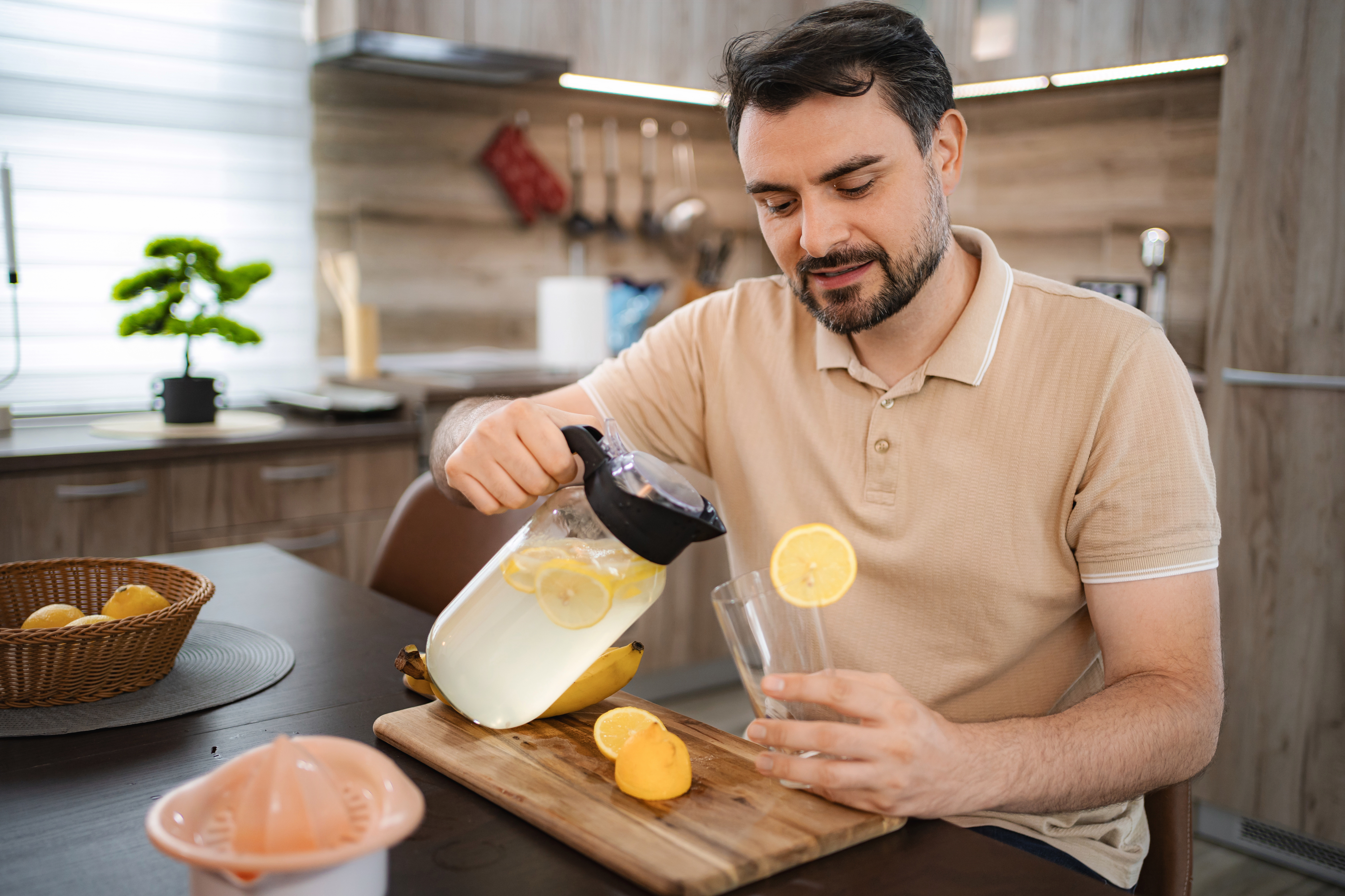 Practical Paths To Sustainable Wellness: Turning Sour Moments Into Sweet Victories 3 Man Pouring Refreshing Lemonade In The Kitchen 9887E118A4910Ed5F0D1