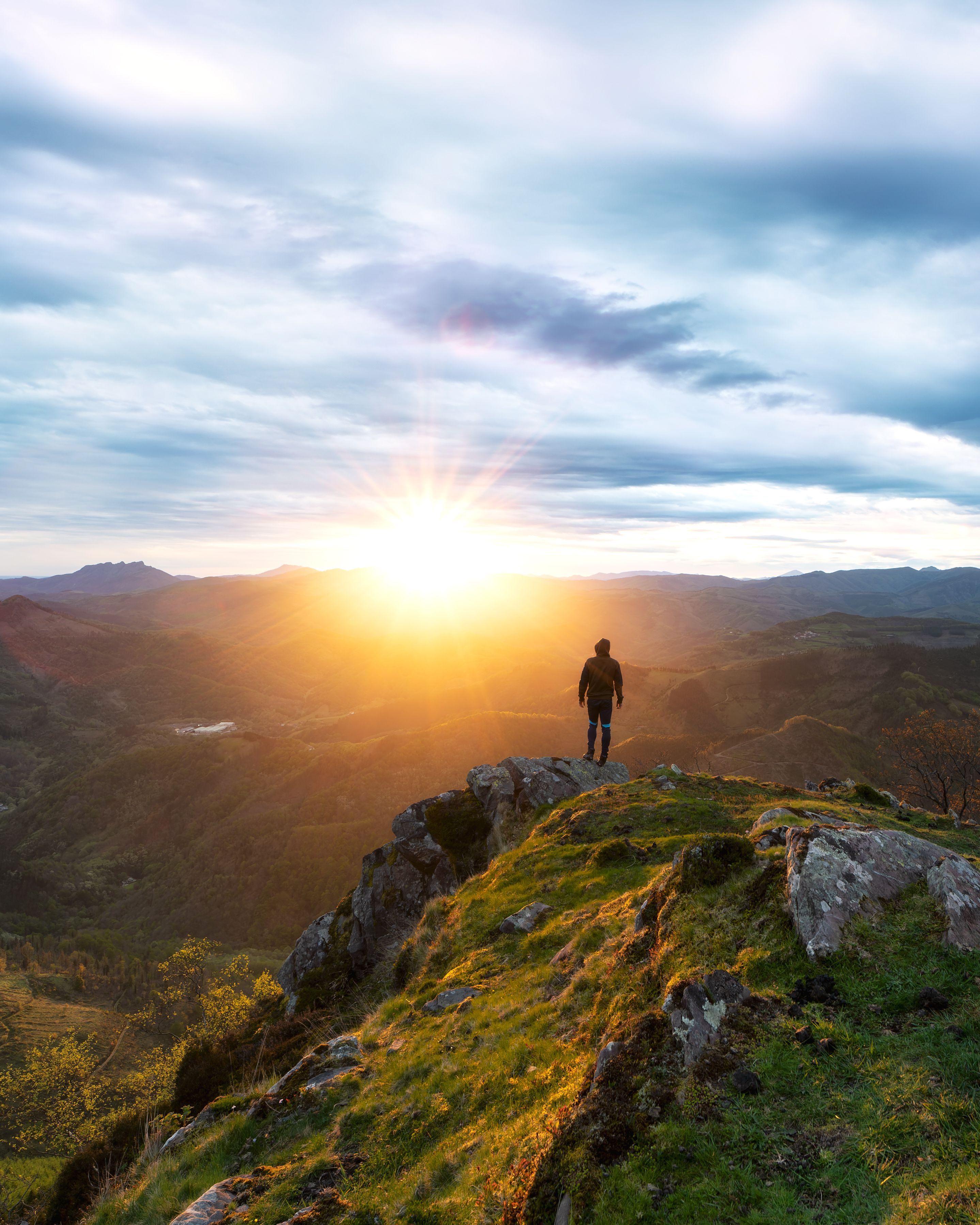 man standing on a large rocky outcropping in a maj db9a01623df6b8037b10
