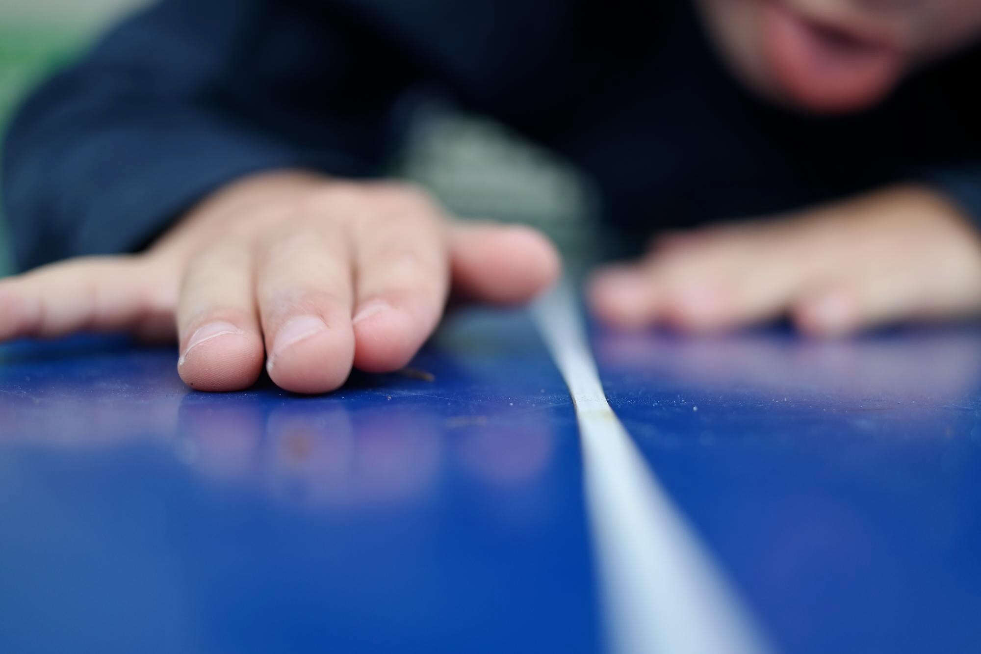 The hidden costs of low-quality plastic sheets in construction and DIY 3 man touching blue surface c062b6158ab20841a9ae