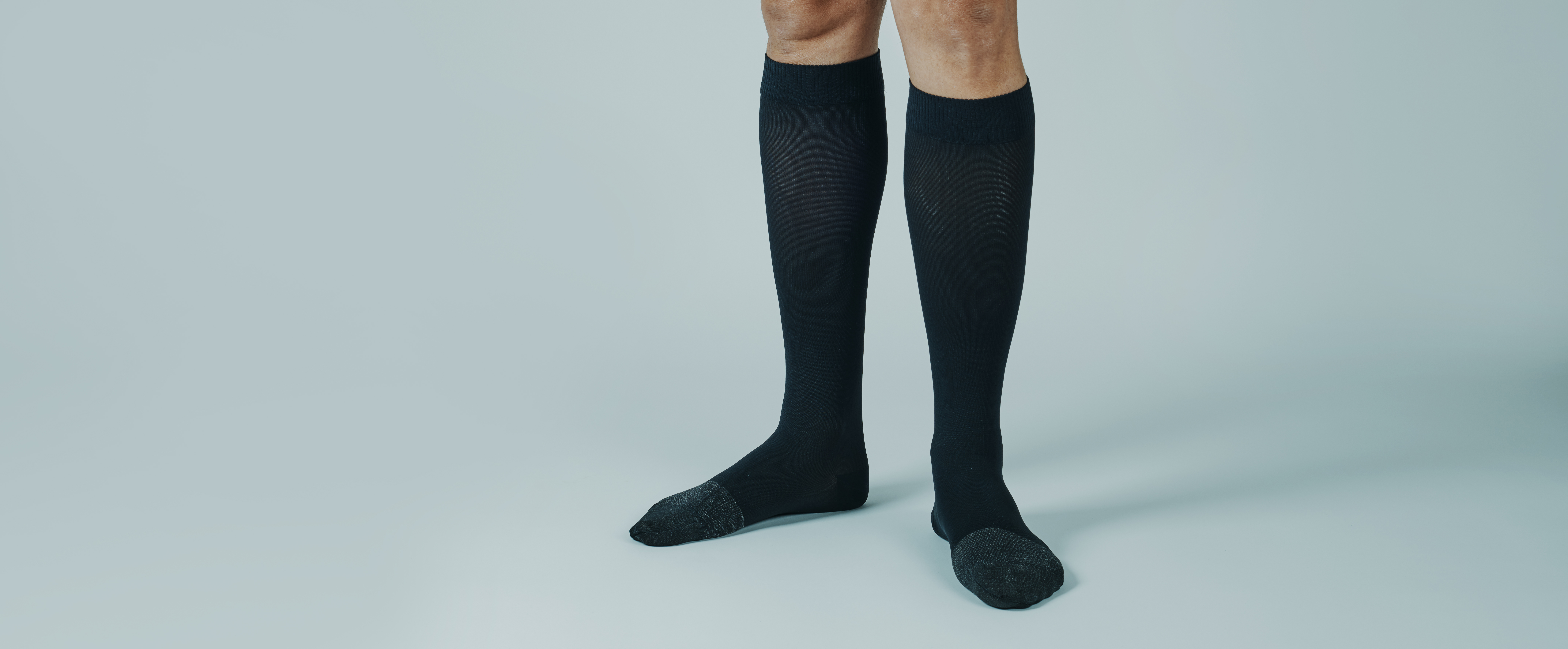 man wearing compression socks banner format 64114265c5d8b5b3400f