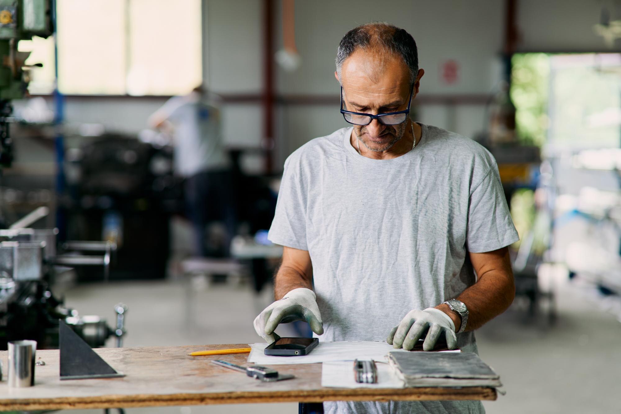 How Custom Plastic Fabrication Lifts Project Outcomes Across Australian Industries 3 mature man wearing gloves using smartphone and too c93c9346c87c08473f1e