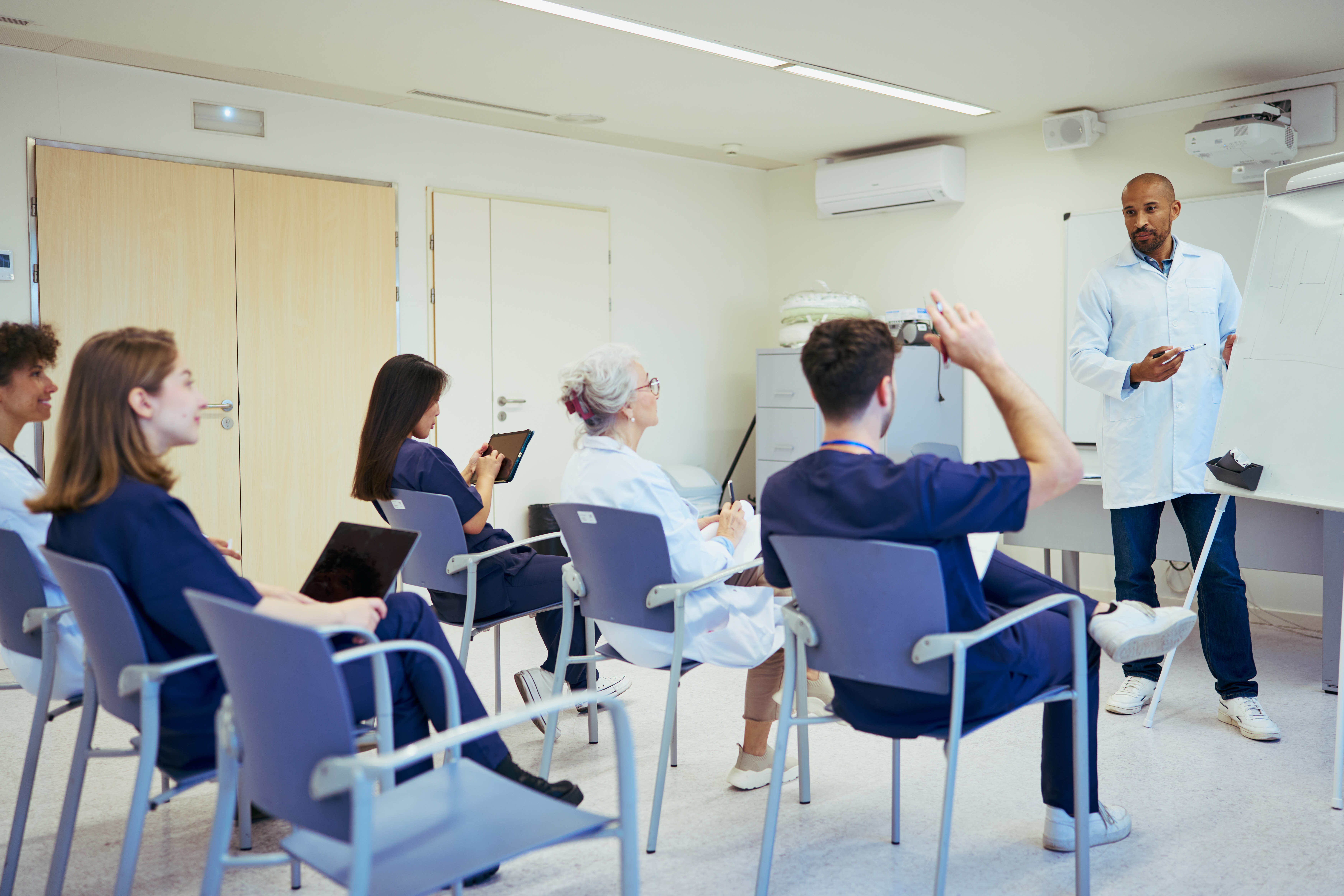 Mastering Oet Listening: Leverage Real-World Healthcare Conversations To Boost Your Skills 3 image of a group of healthcare workers in a classroom. An illustrative image for healthcare conversation and OET preparation.
