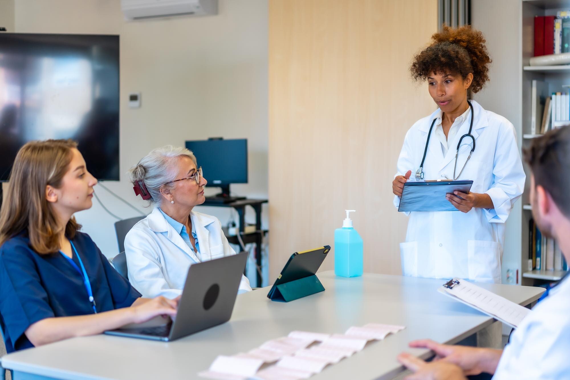 medical team meeting discussing patient cases in h a0c24fc2908a62d86f07