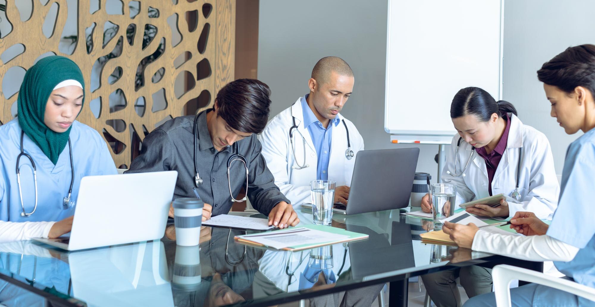 Medical Team Working Together At Table In Hospital Ccac889f4d3071c40b5d