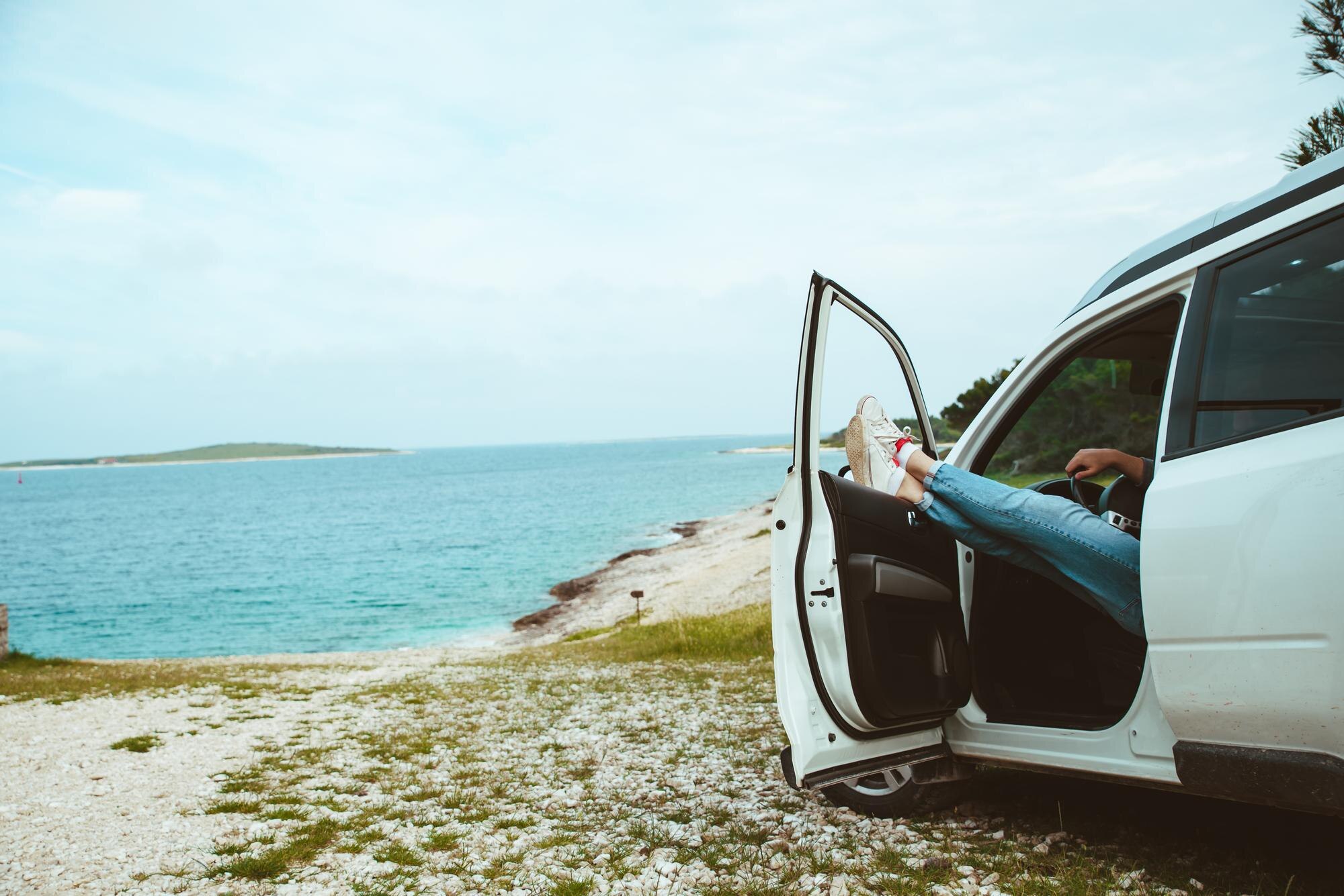 men legs stick out from car parked at sea beach su 73d610eed11530b6fee2 BTOURS