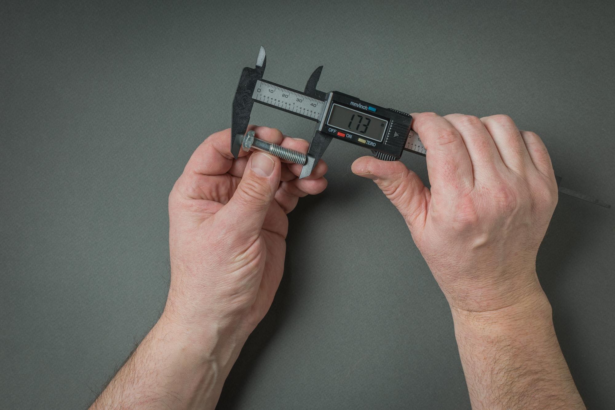 Cut-to-Size Plastic Sheets: Why Precision Matters for DIY and Trade Projects 2 mens hands measure the screw using an electronic c 0297fc882ab86c97d7a3