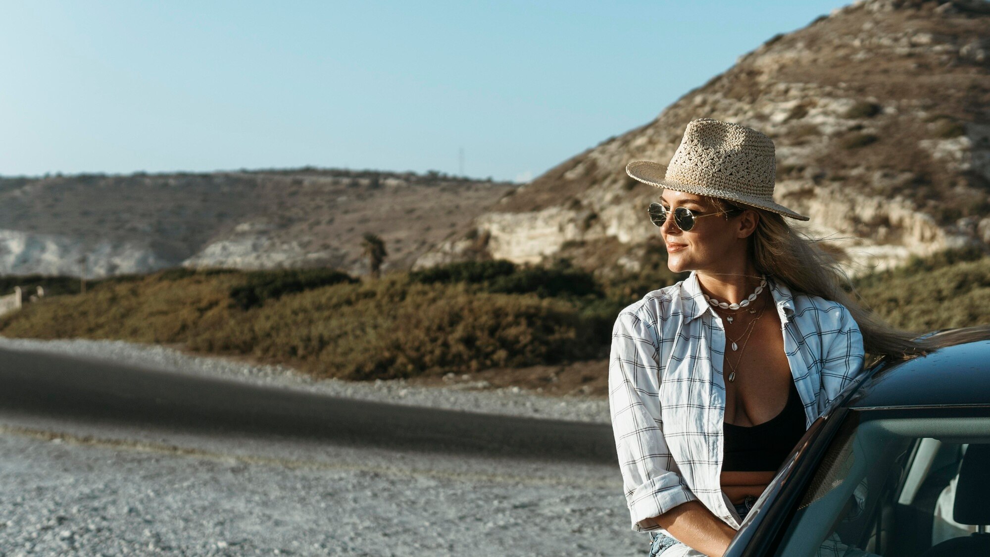 mid shot blonde woman standing out of car window o 7404a858106f206fa584 BTOURS