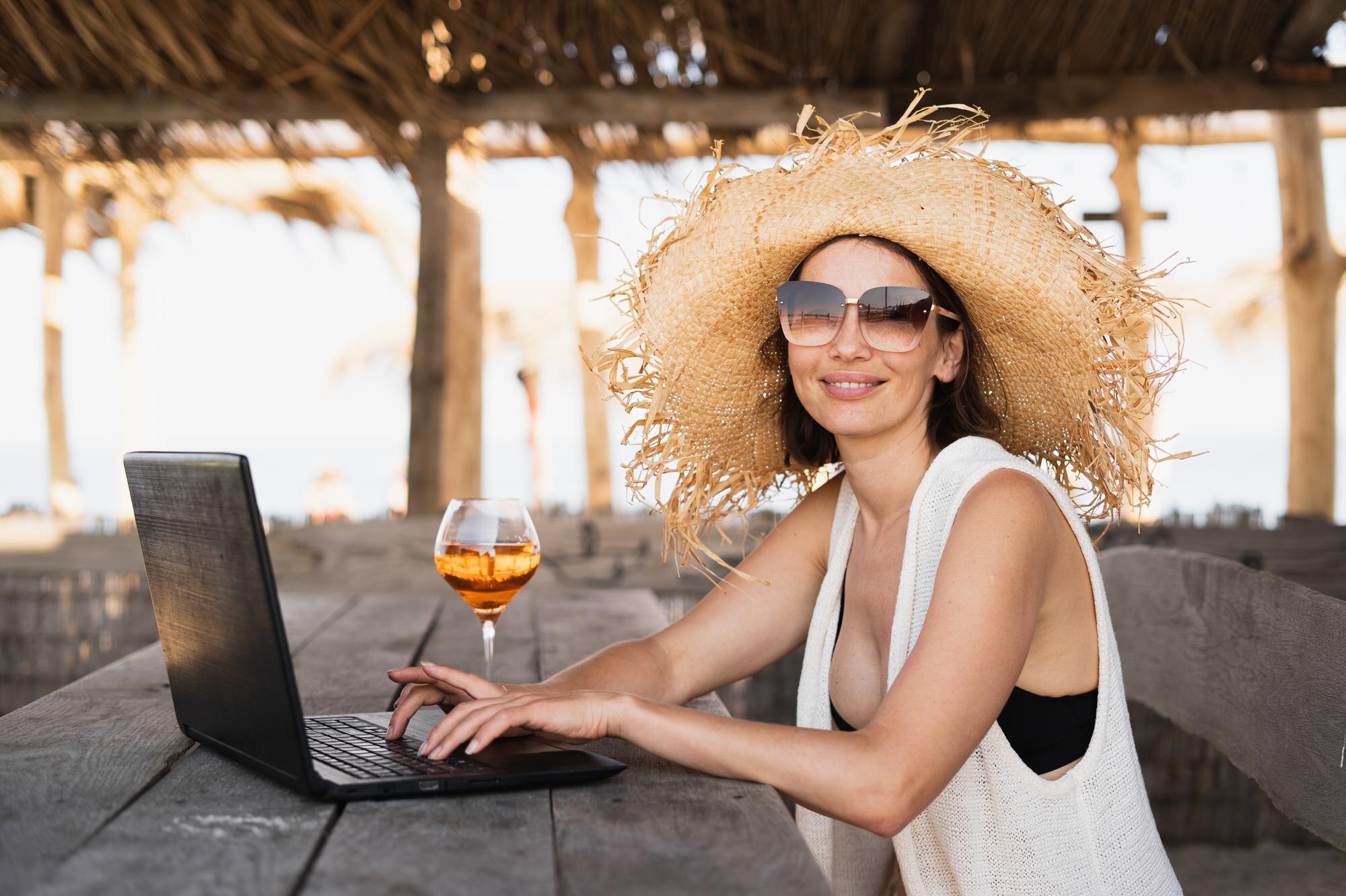 Mastering the Work-From-Anywhere Lifestyle: Tips for Aspiring Travel Entrepreneurs 1 millennial woman sits at a table in a tropical caf 263f81581deb02ab822b