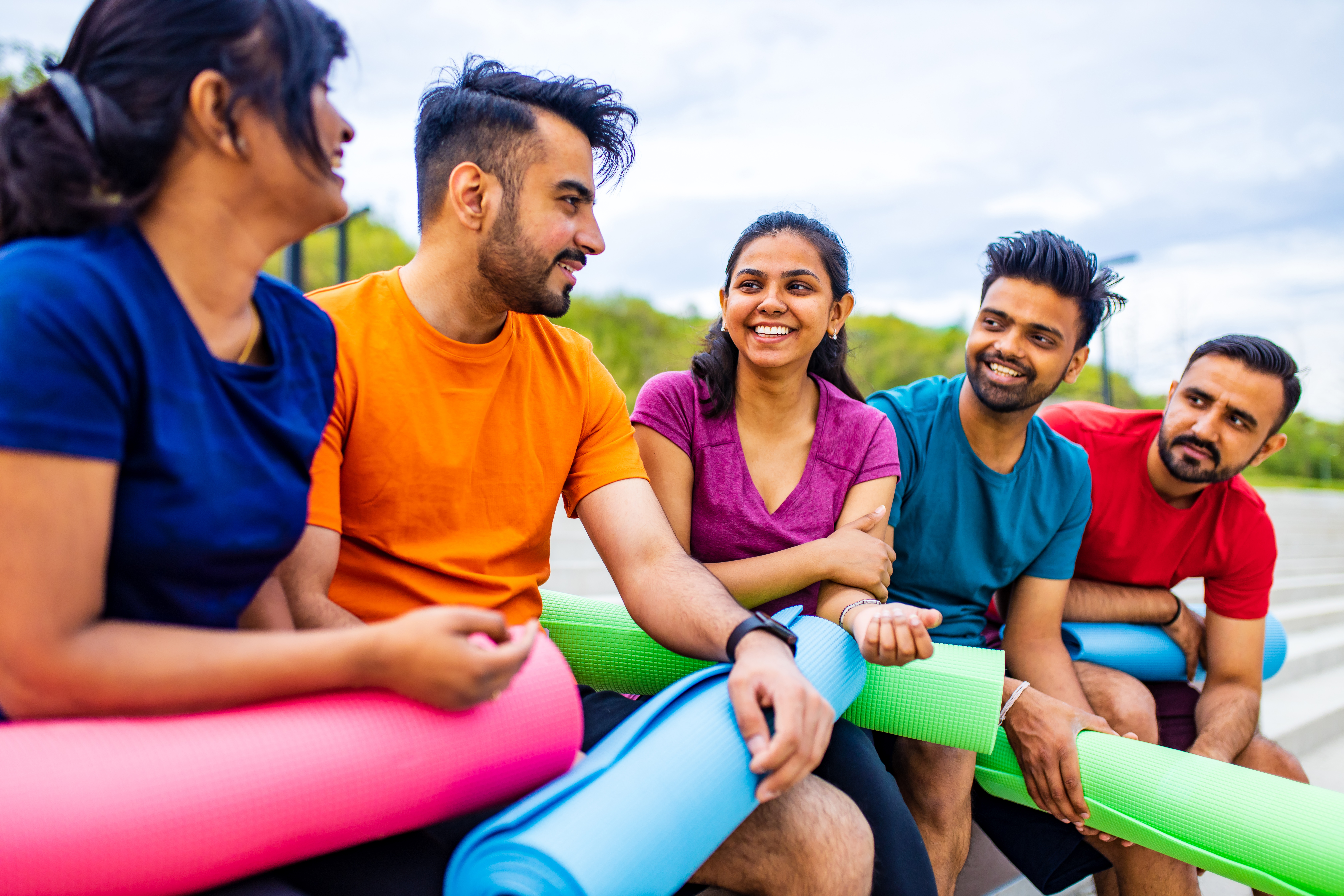 mixed race four people talking sfter training in a a53bc6189d06e2f22dbc