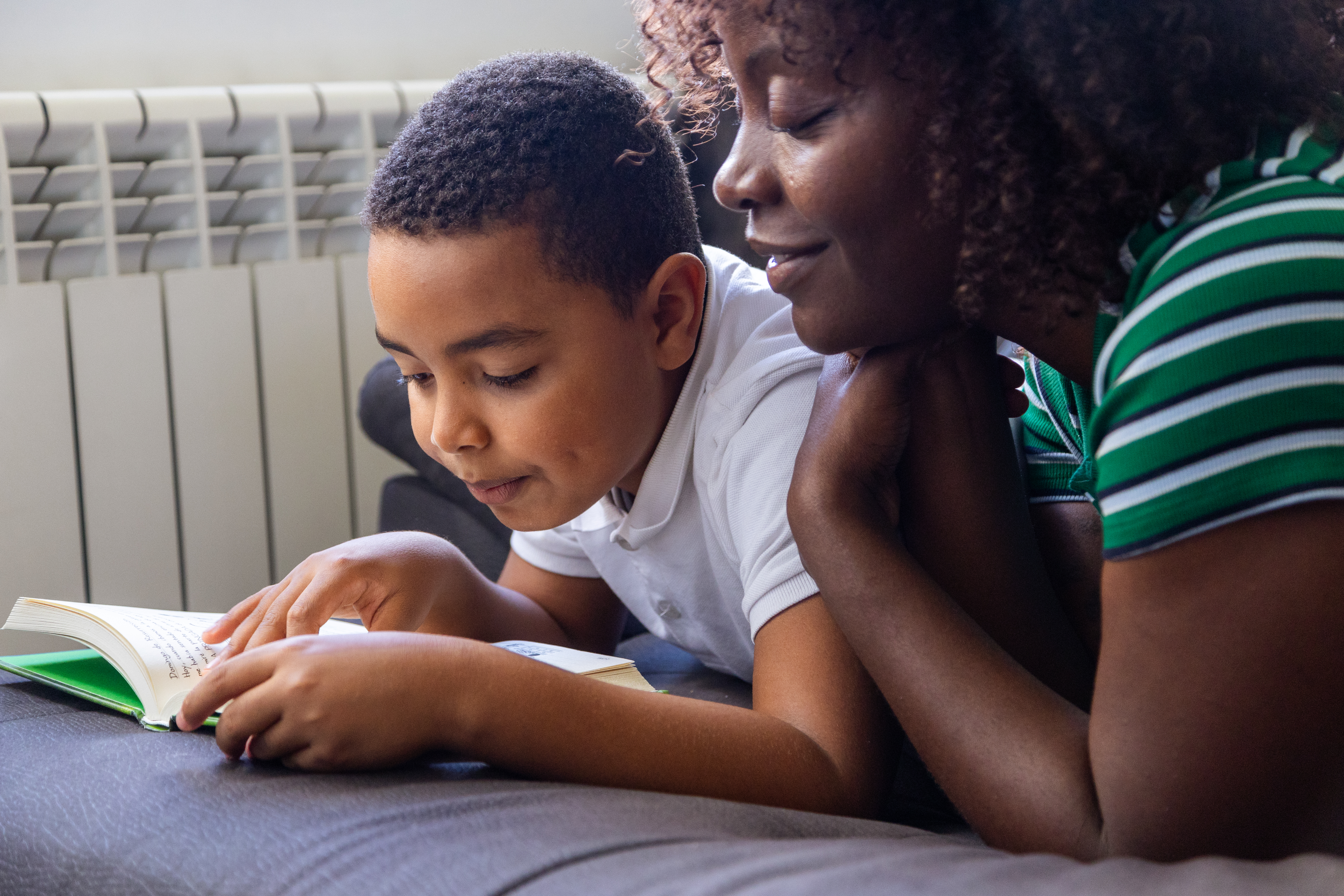Mother And Son Reading A Book Together At Home 9bb4c93b4613cbe18c5b