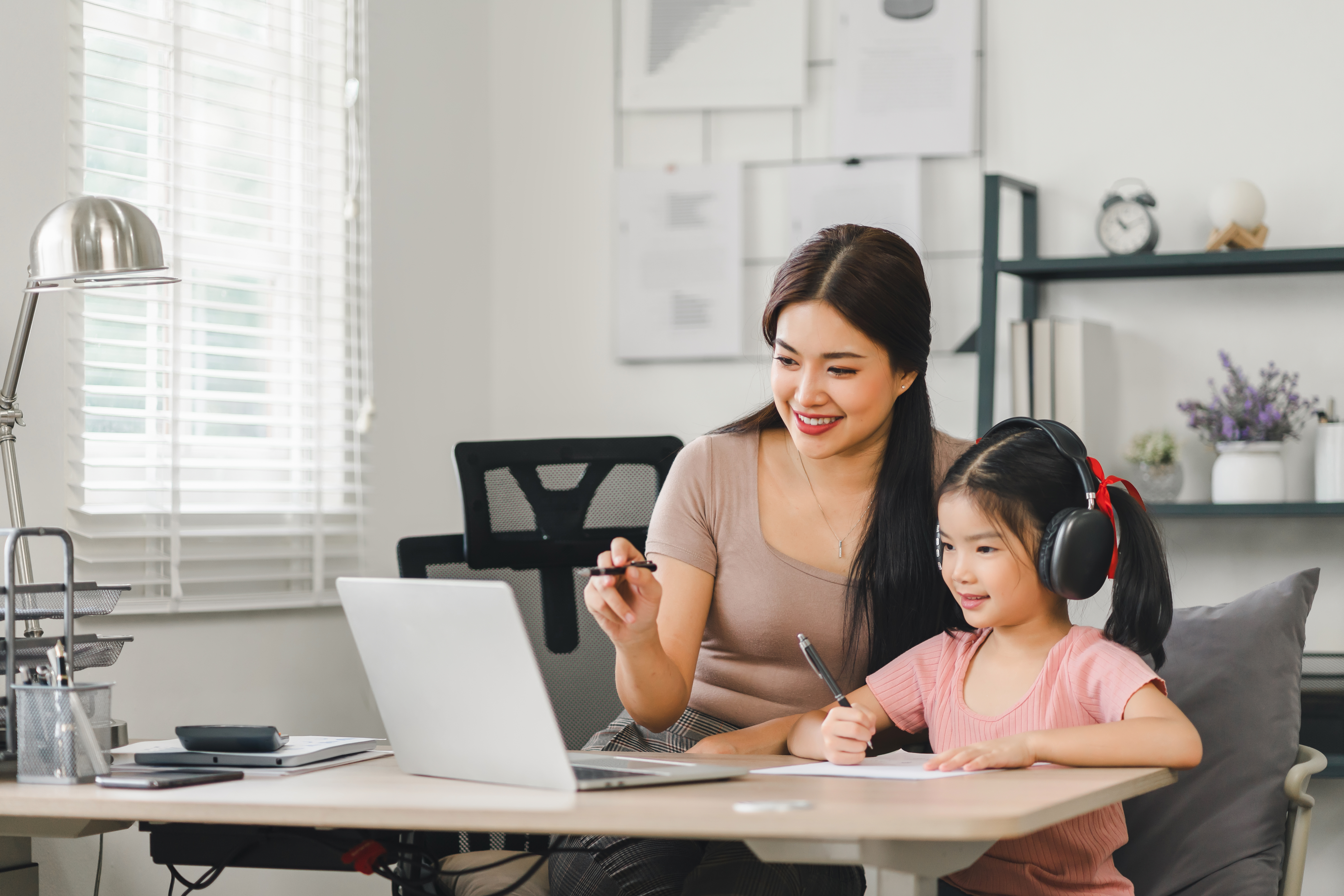 Mother Helping Daughter With Online Learning A51092a8a30eb3123673