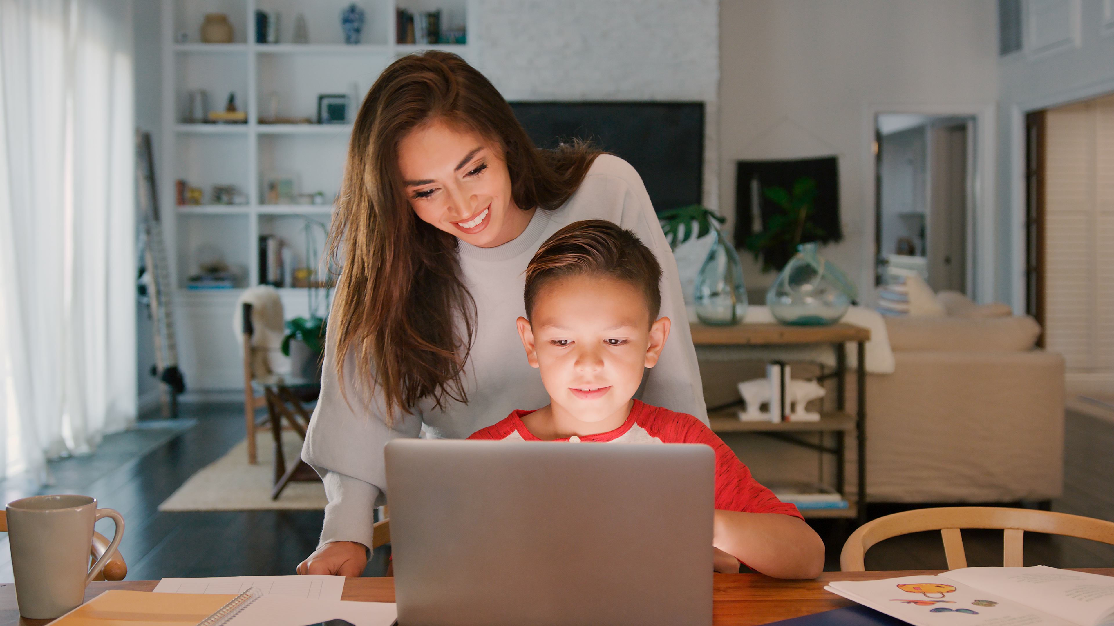 Mother Helping Son Studying Using Laptop At Home T 3dcc8e5ad63b0d02d75e