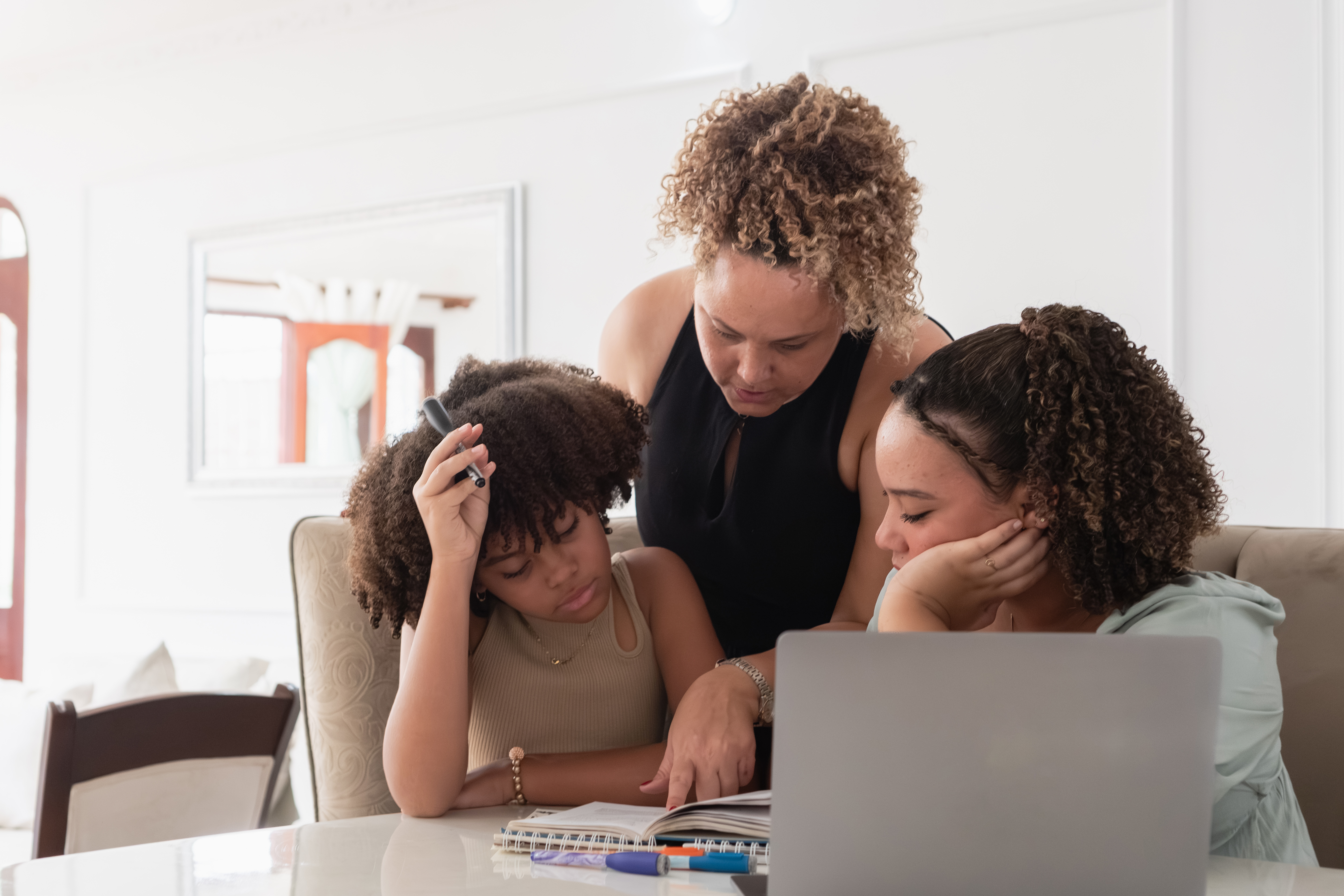 Mother Teaching Daughters Doing Homework At Home Ff308ac7852fb2d71ba7