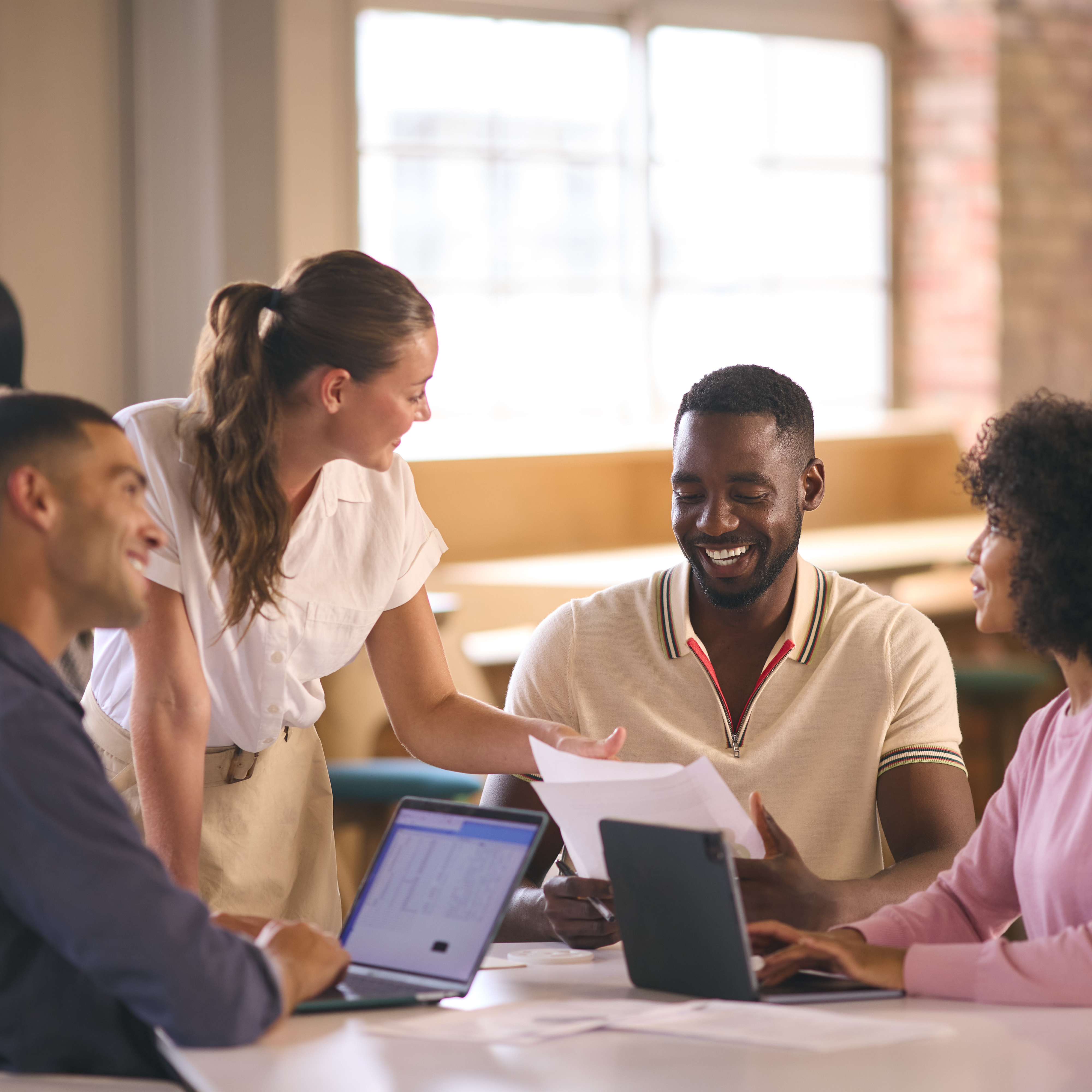 multi cultural business team meeting around desk i ba963836f4a6efe41087