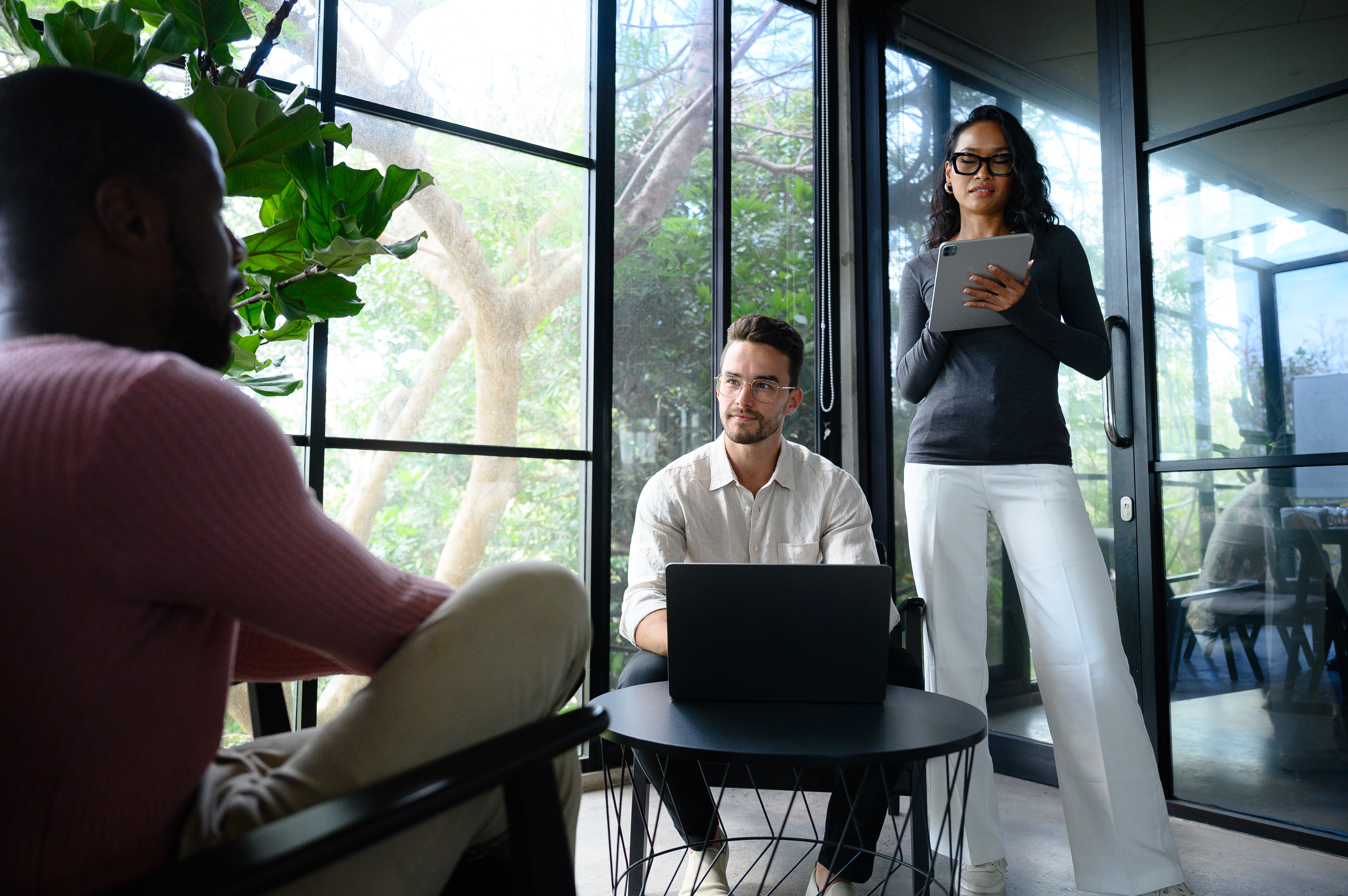 Multiracial team collaborating in a modern office setting, discussing strategies for online reputation management and AI tools for Google Business Profiles.