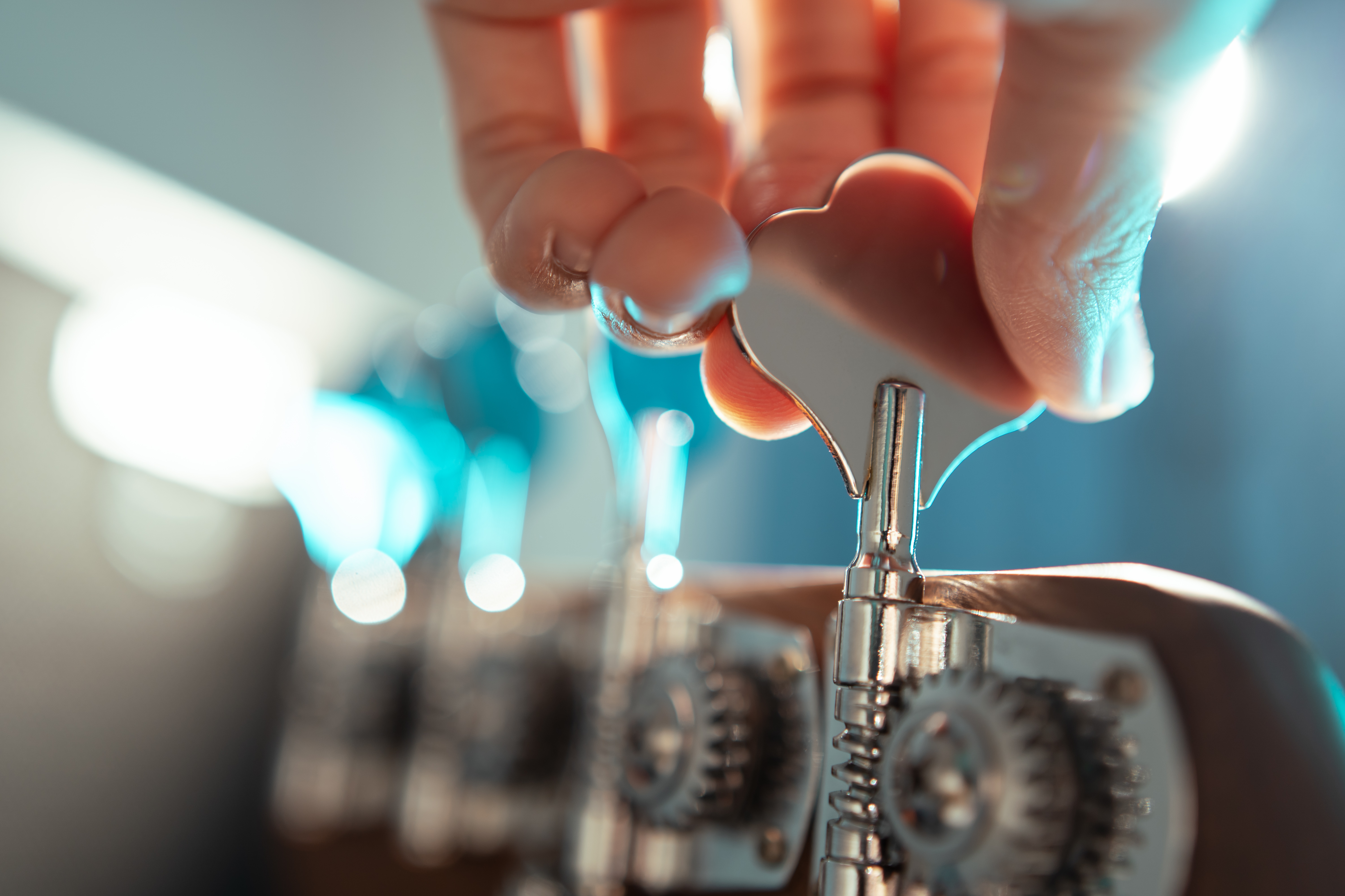 a close up of a hand tuning a bass