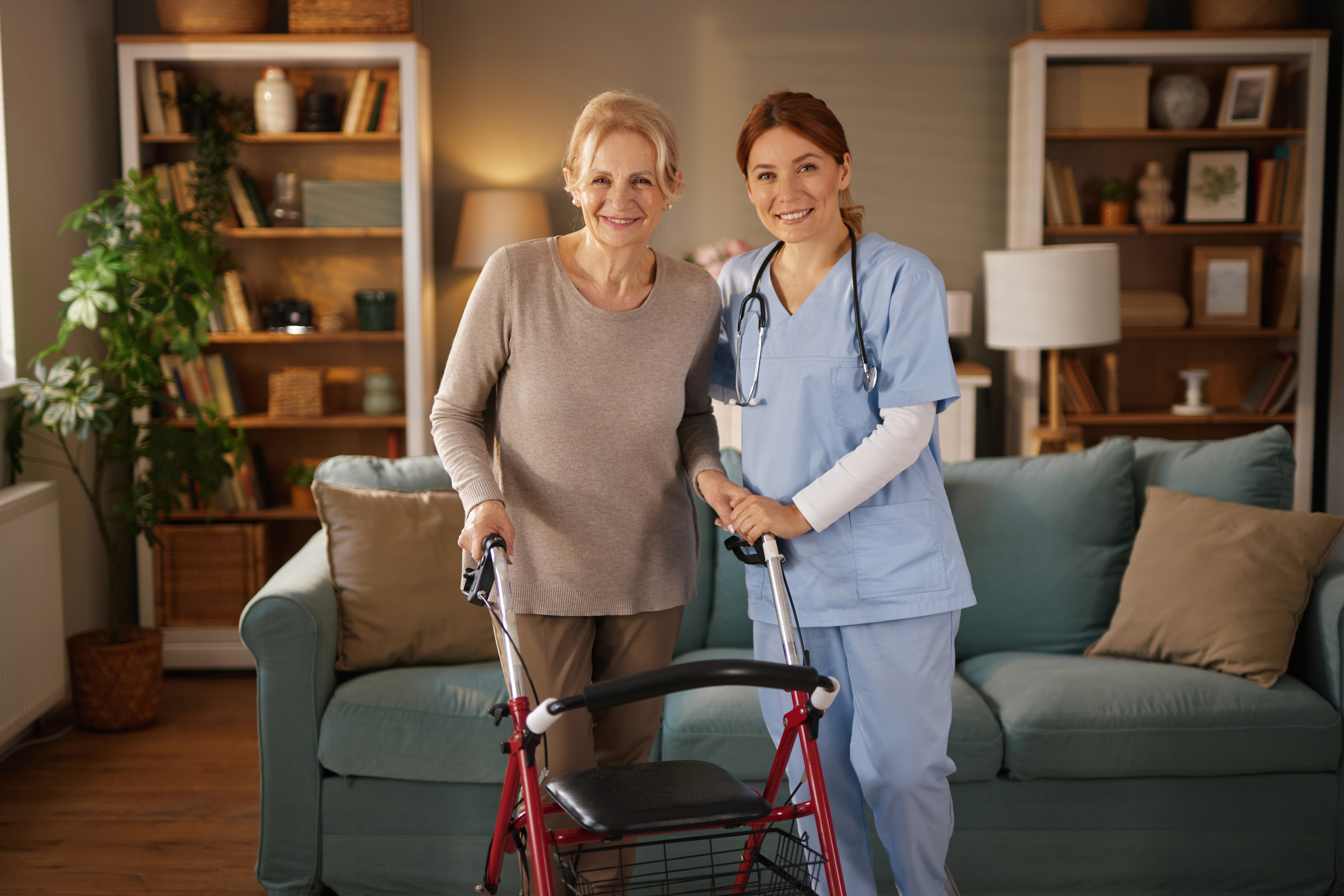 nurse assisting elderly woman using walker in livi 21fceea6db6c3aaad3ce