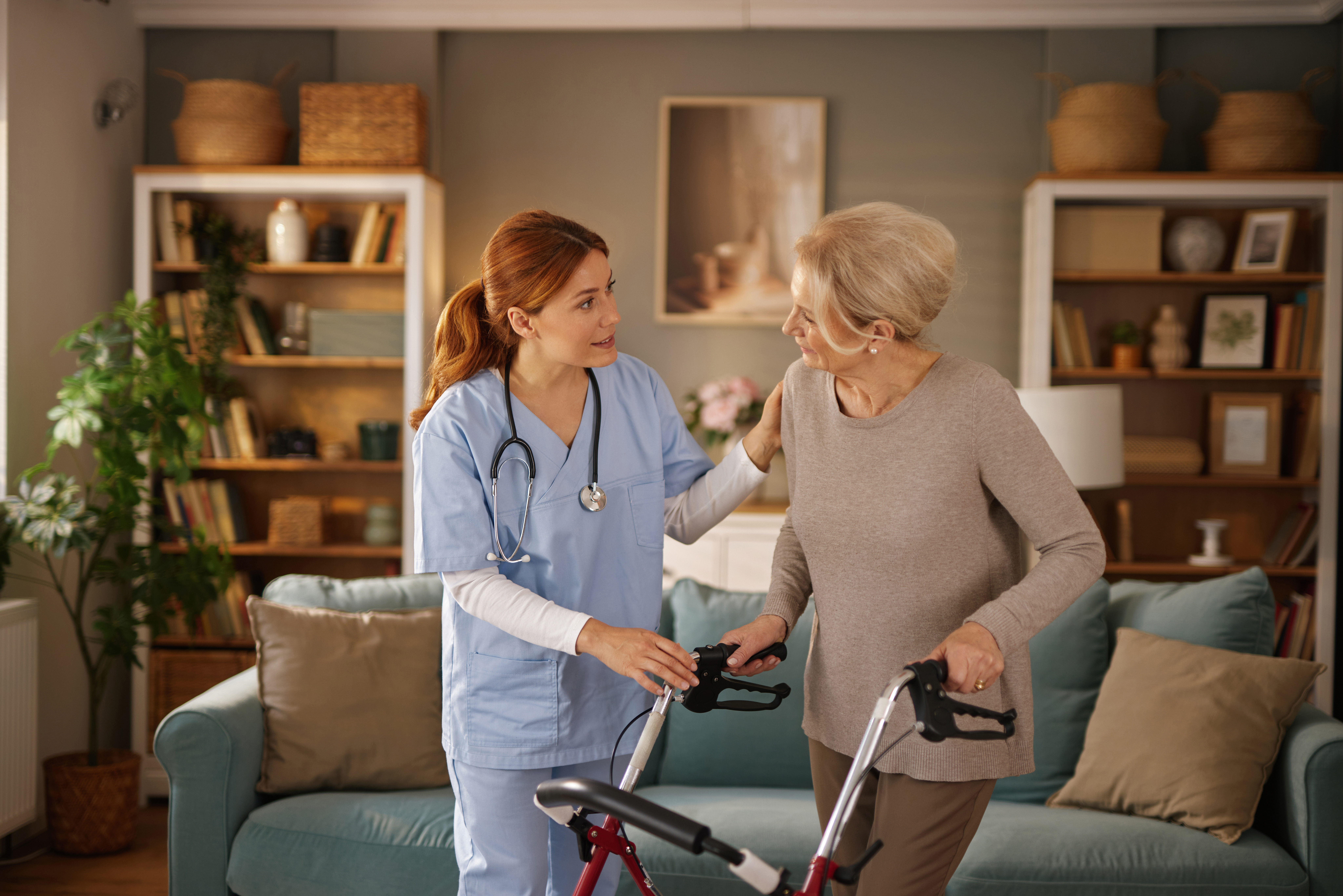 nurse assisting elderly woman using walker in livi af9a9fbff241f262e85b