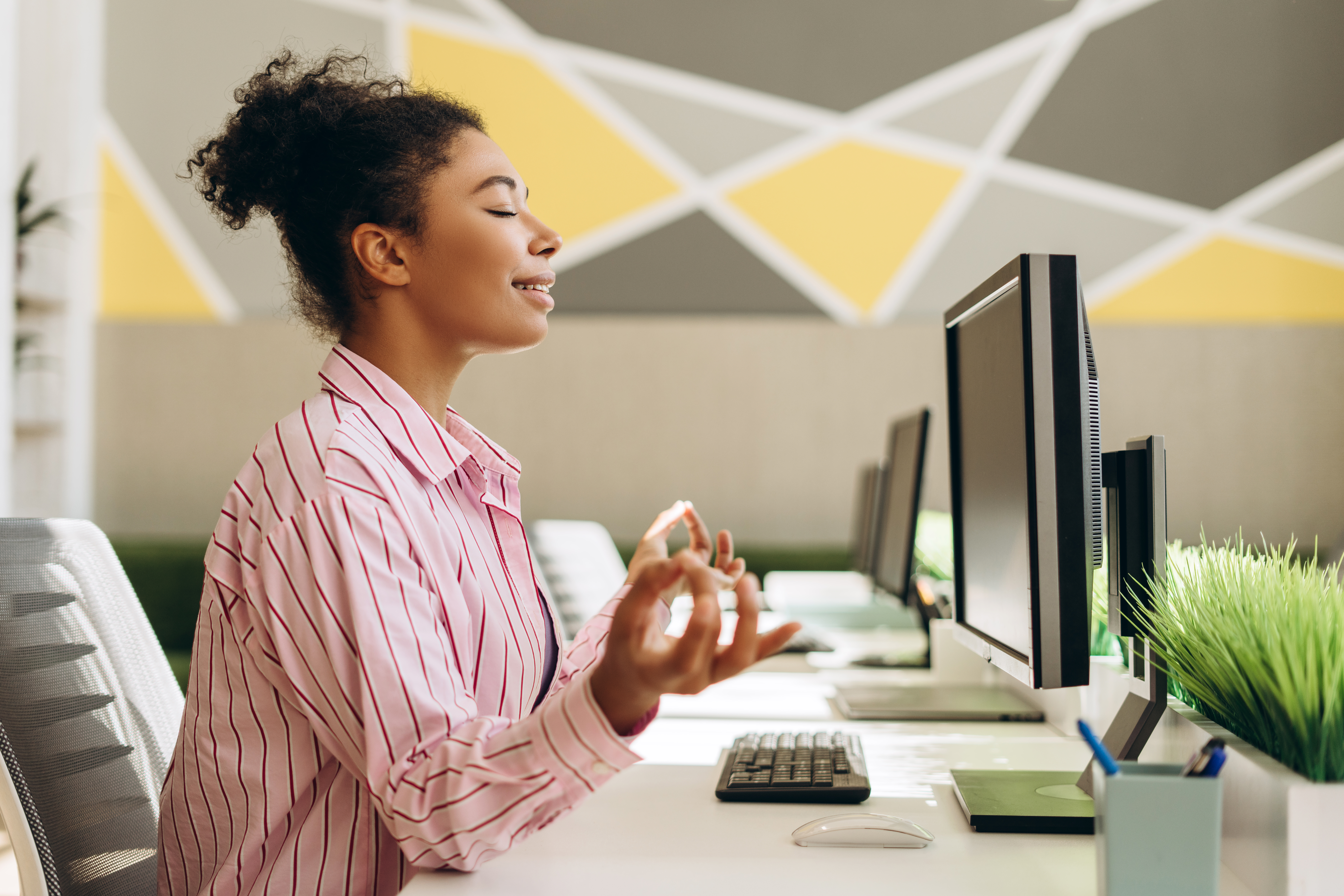 office worker meditating at her desk for stress re 4e20e0a19aed55b07516