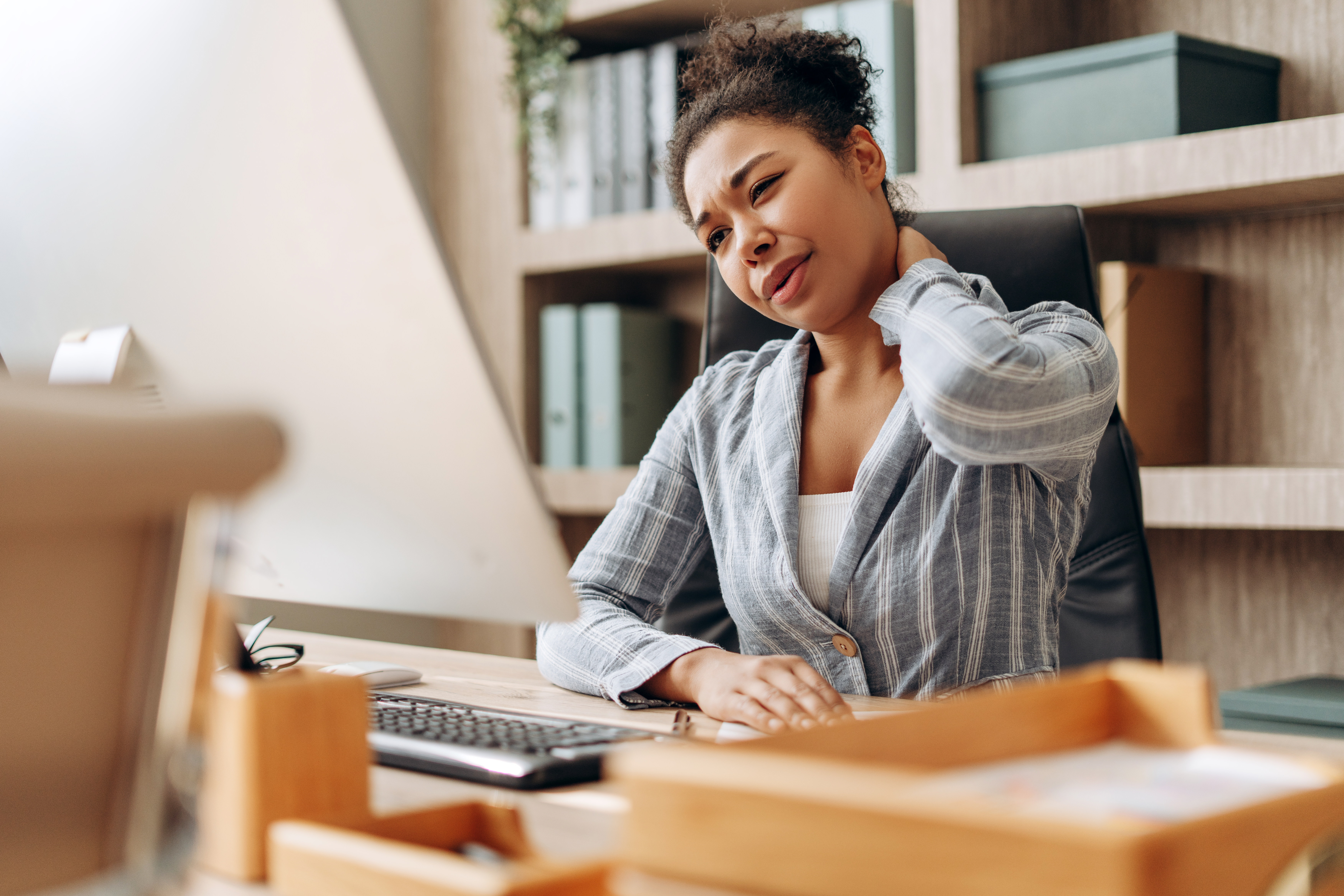 office worker suffering neck pain at work using co 23b679e9ca127ad584b7