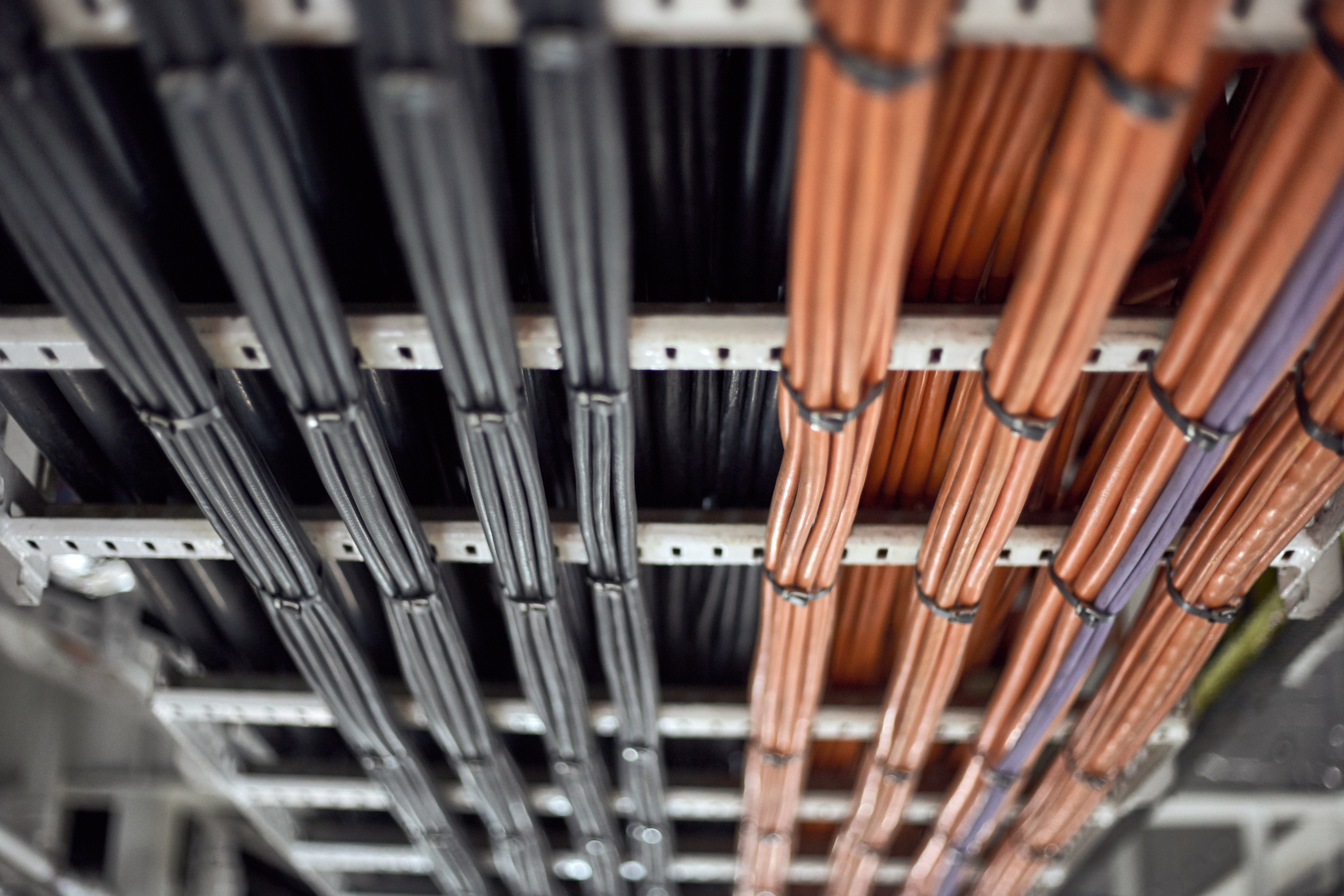 orange and black power cables vertically secured b c236fe9d4413adef0c82