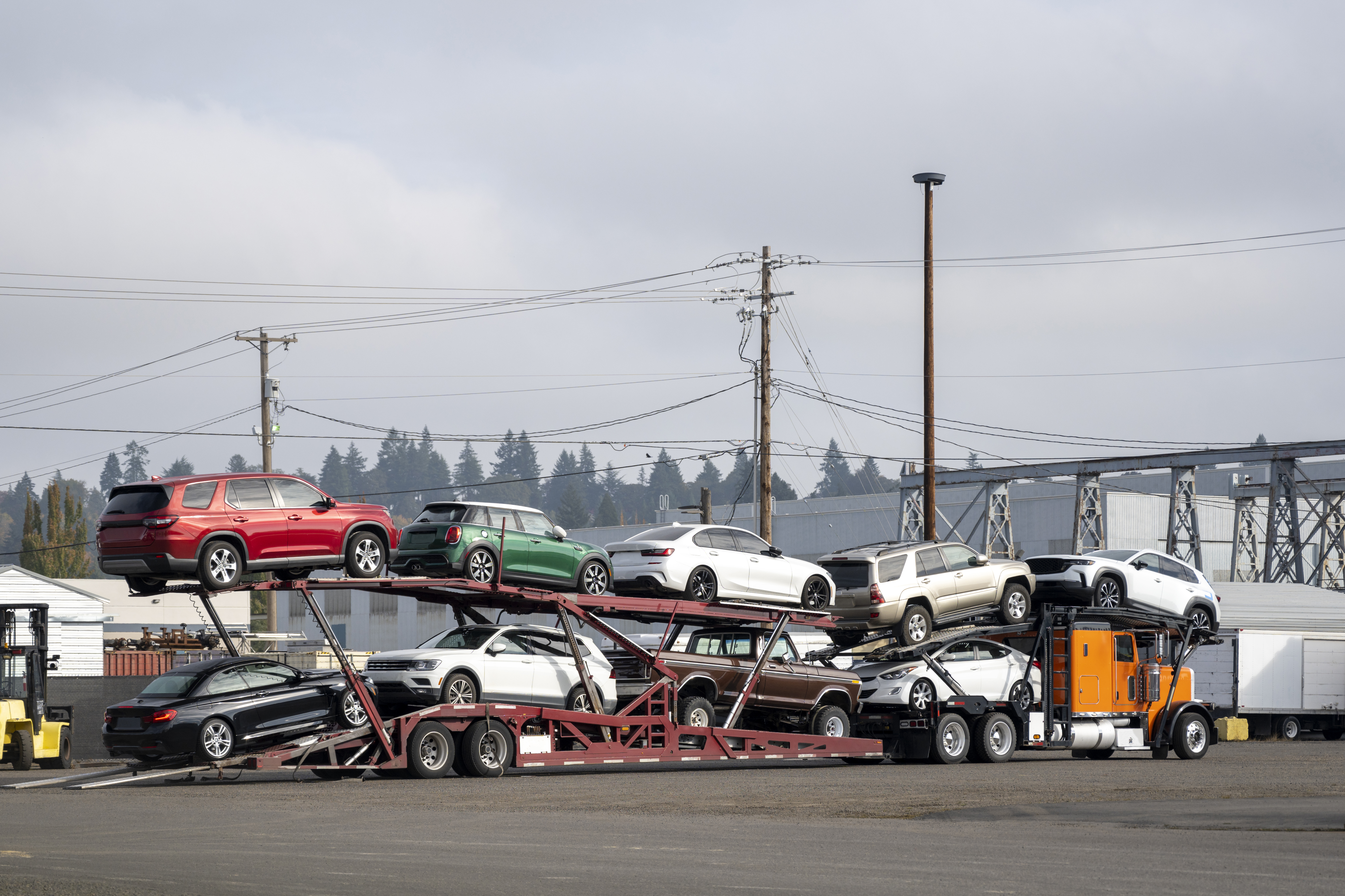 orange car hauler big rig semi truck loading cars ac7283ff2e3573d511b0