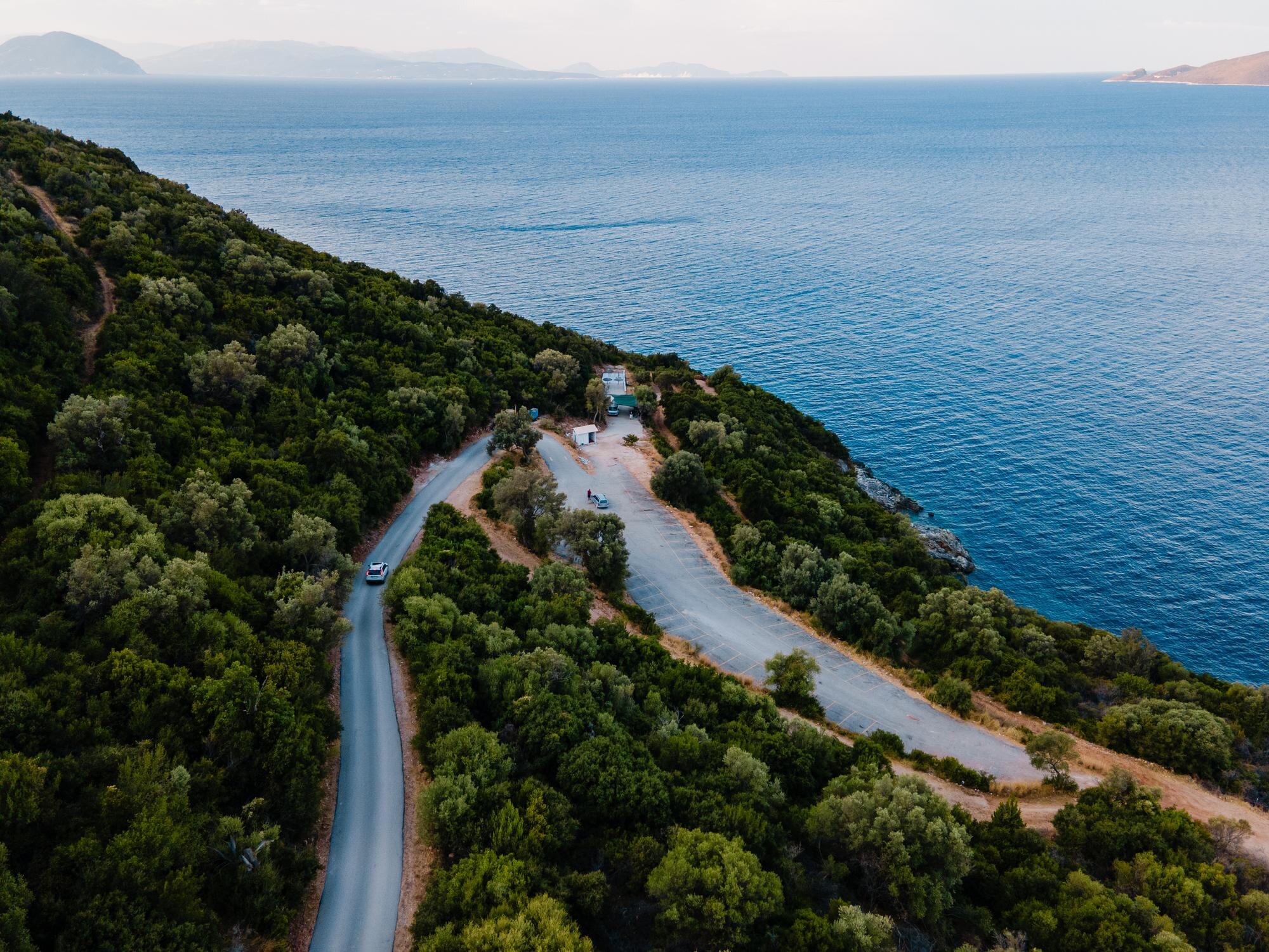 Stay in Style: Discover Our Top Quality Accommodations for Your UK and Greece Road Trips 5 overhead view of car moving by road next to sea sh cb4d301202d6ceea3851 BTOURS