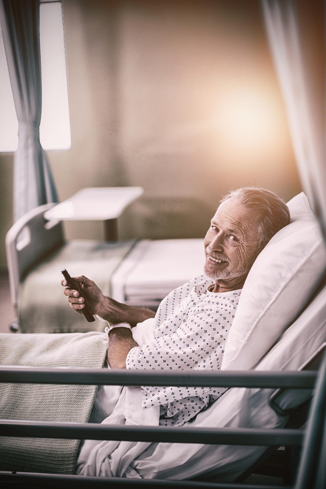 patient watching television on bed 08286a3cf4a8dce5e217