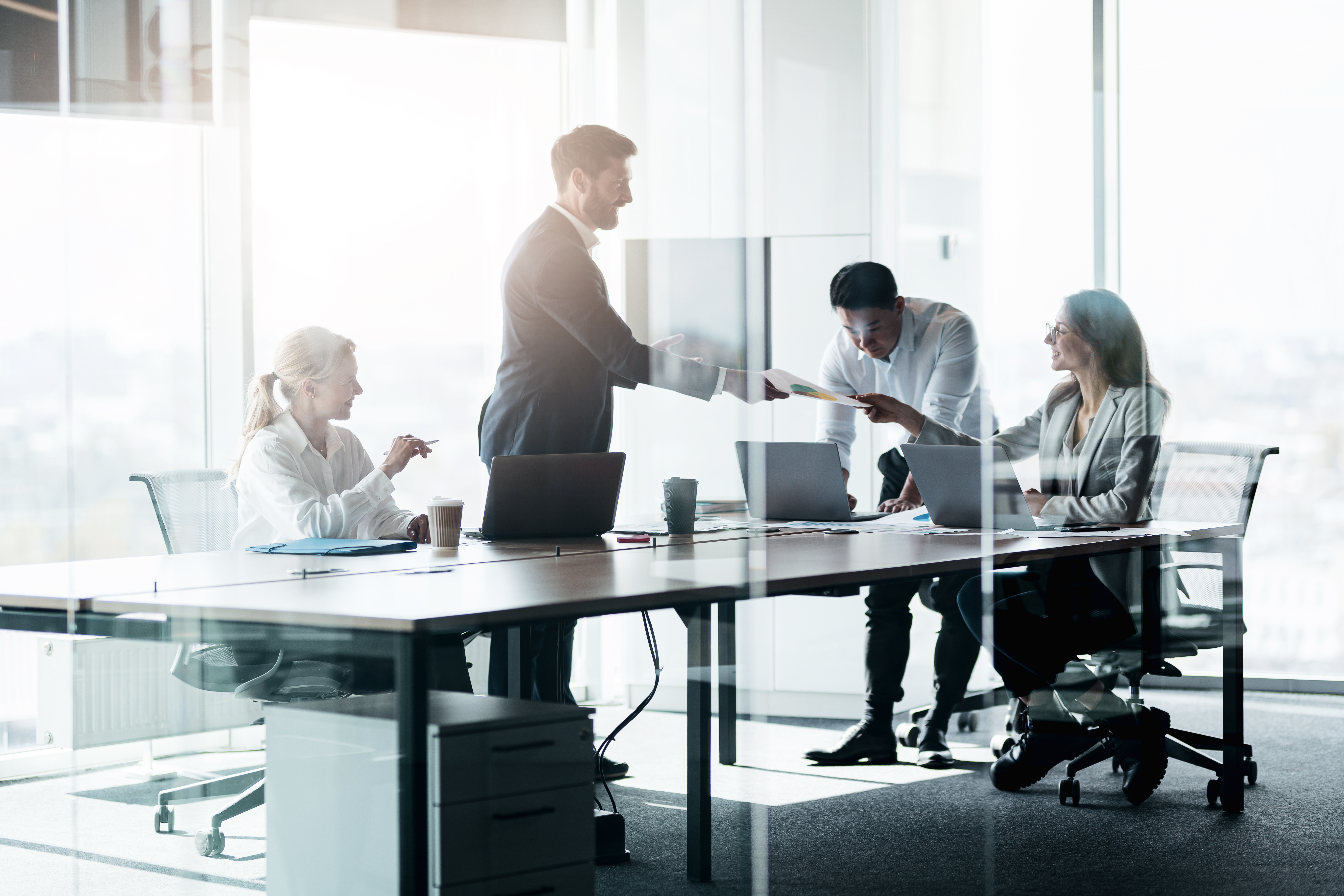 people standing near table team of young business e205c29140a08c561f8c